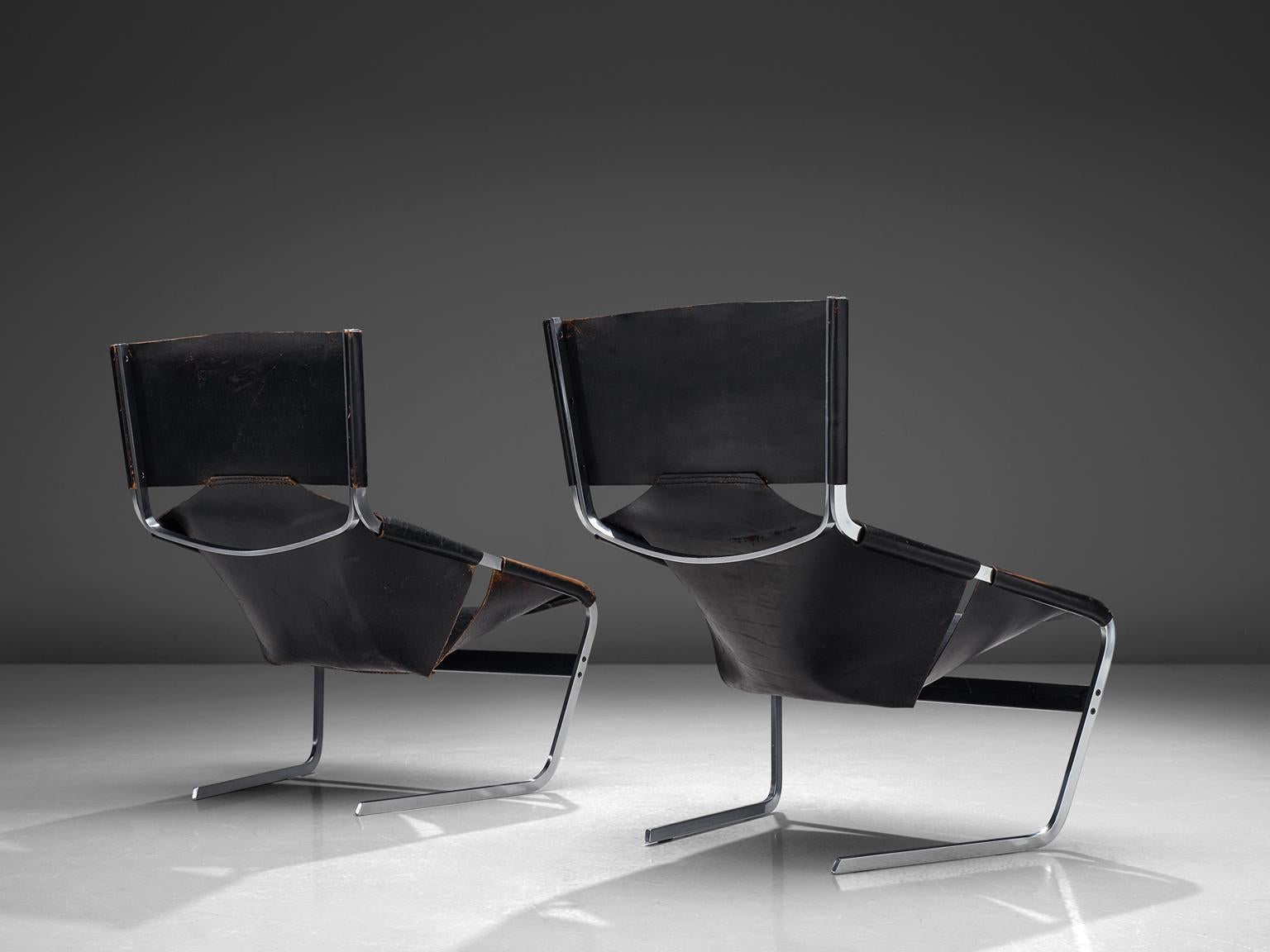 Pierre Paulin for Artifort, F444 easy chairs, metal and black leather, the Netherlands, circa 1962.

These black leather F-444 chairs are designed by Pierre Paulin for Artifort in 1962. The chairs show sharp lines and features an angled open seat