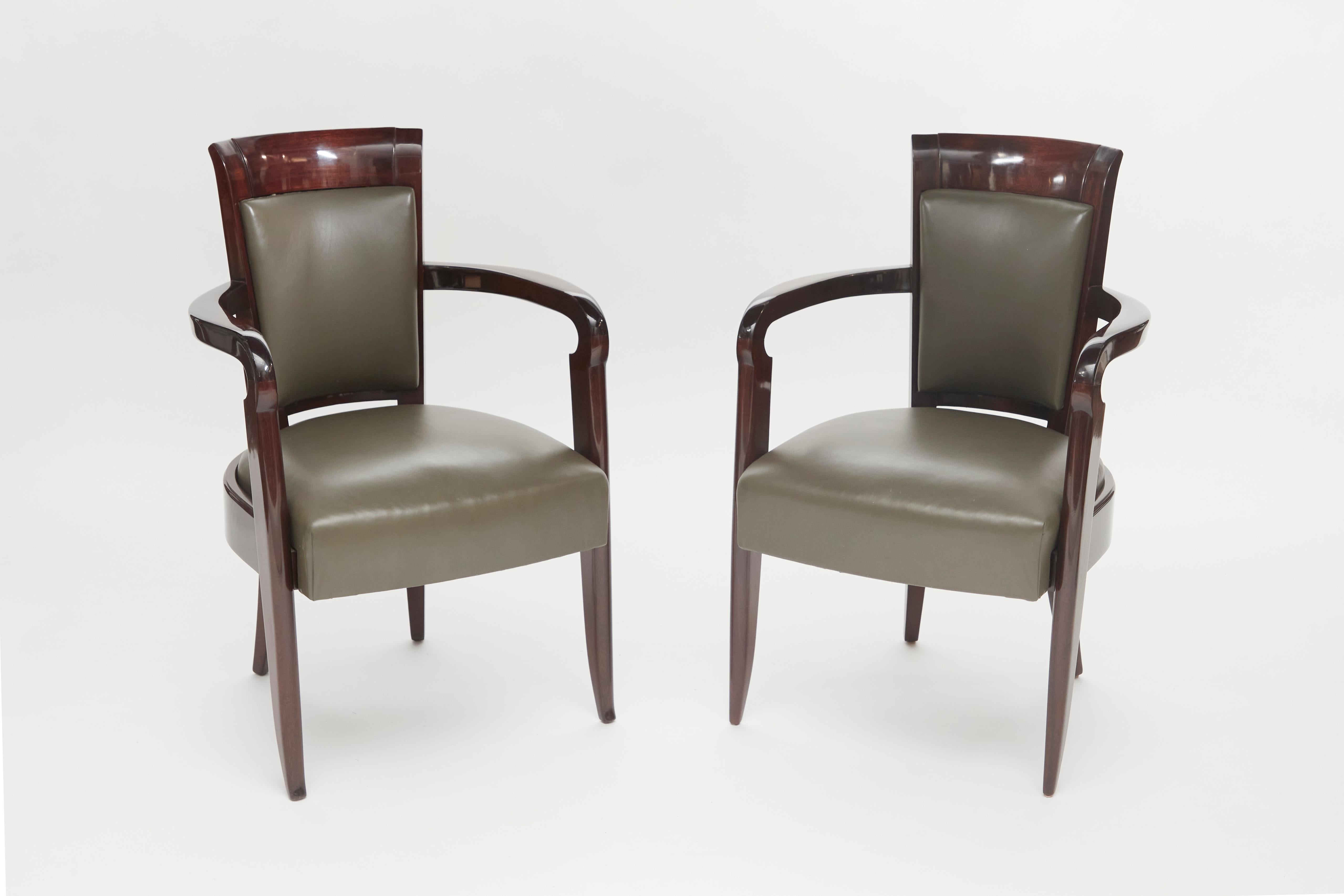 This pair of chairs features delicately splayed legs, high backs, and well-distanced, curvaceous arms. The style reflects the designer's many commissions for luxury ocean liners such as the SS Normandie.