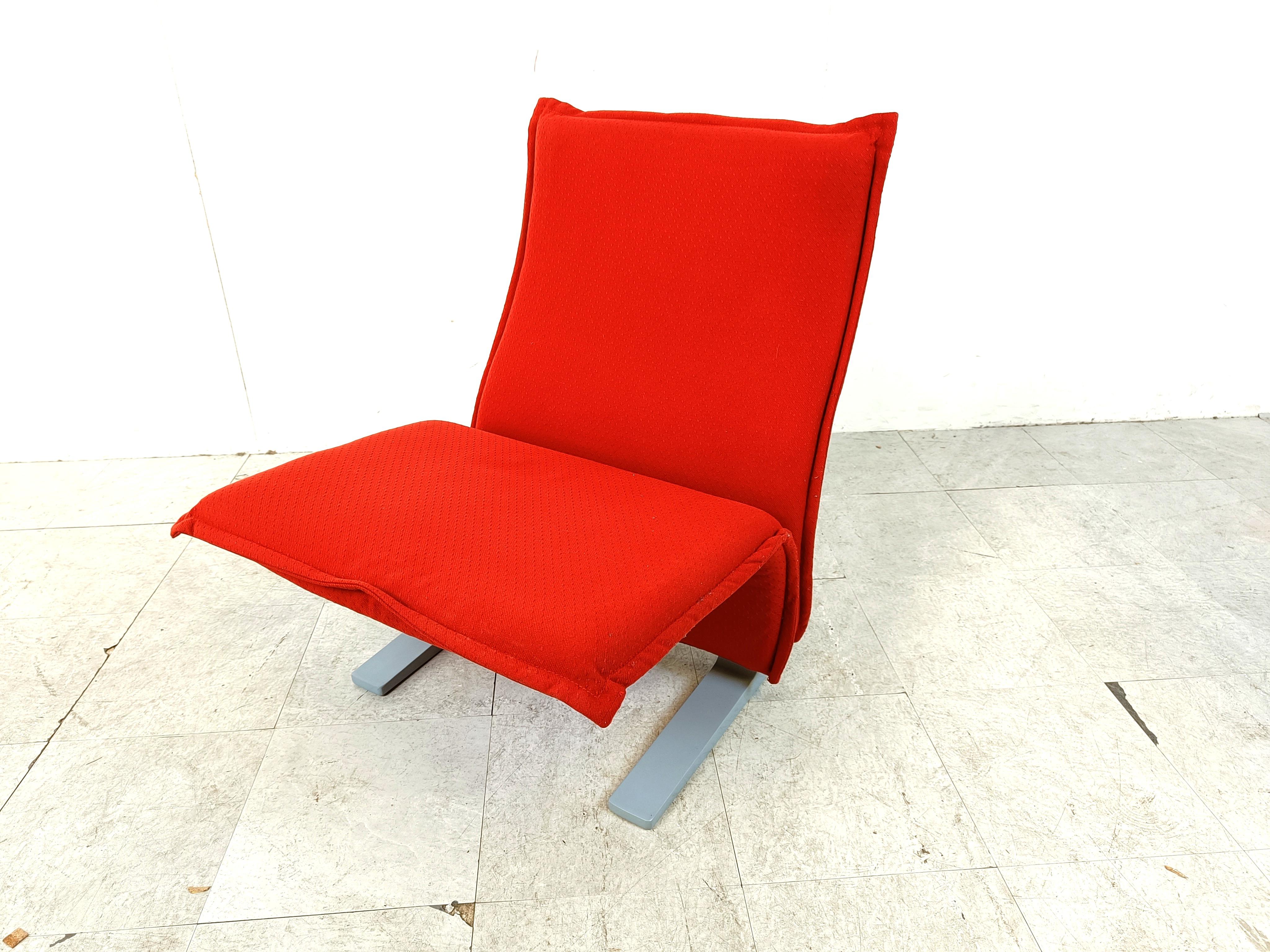 Iconic 'Concorde' lounge chair model F784 -  designed by Pierre Paulin for the waiting spaces of the famous Concorde airplane.

The chair has a timeless design with itsd original red/orange fabric.

The chairs have lacquered metal bases.

1970s -