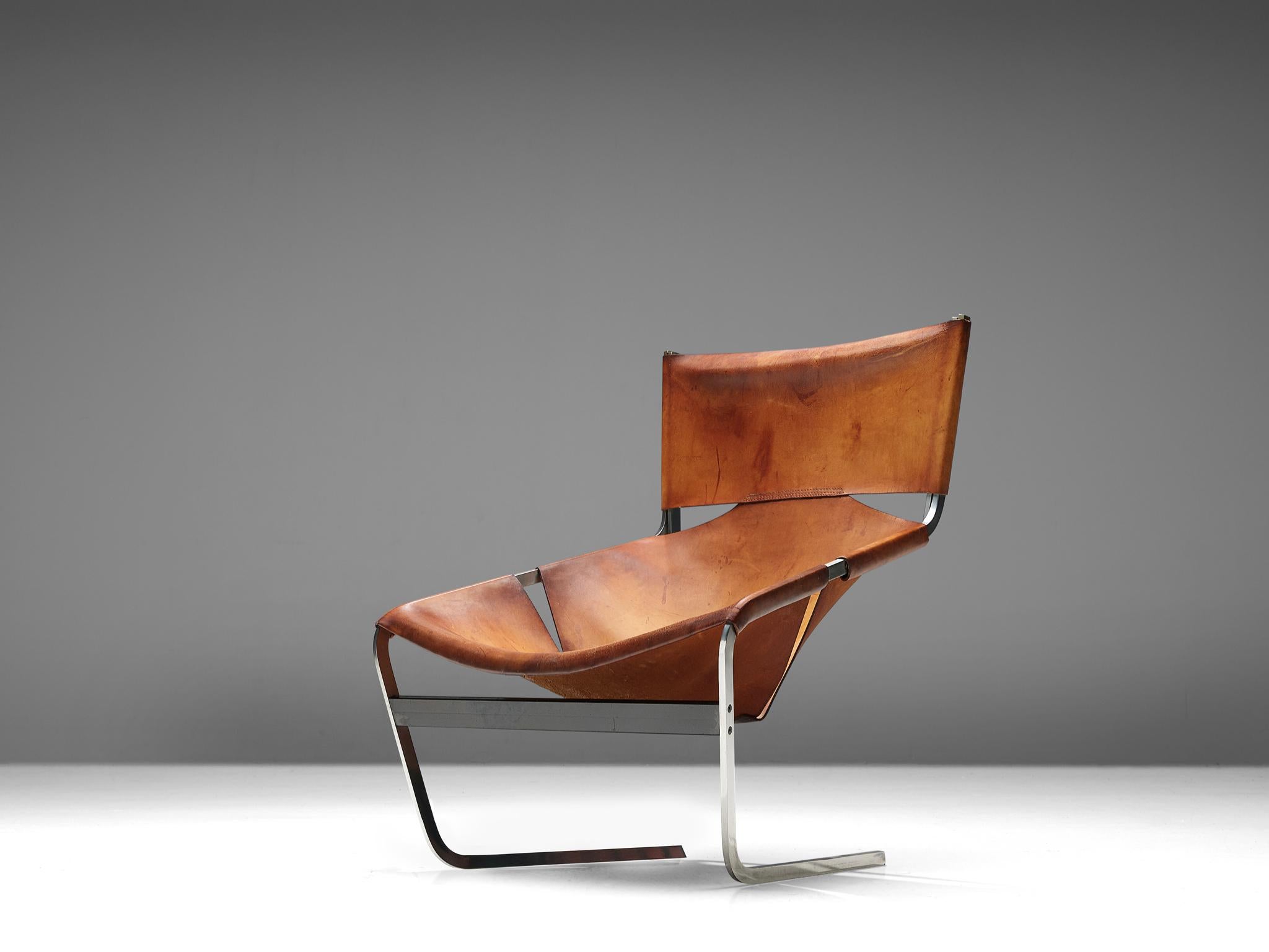 Pierre Paulin for Artifort, F-444 easy chair, metal and cognac leather, the Netherlands, circa 1962.

A cognac leather F-444 lounge chair, designed by Pierre Paulin for Artifort in 1962. The chair shows sharp lines and an angled open seat that