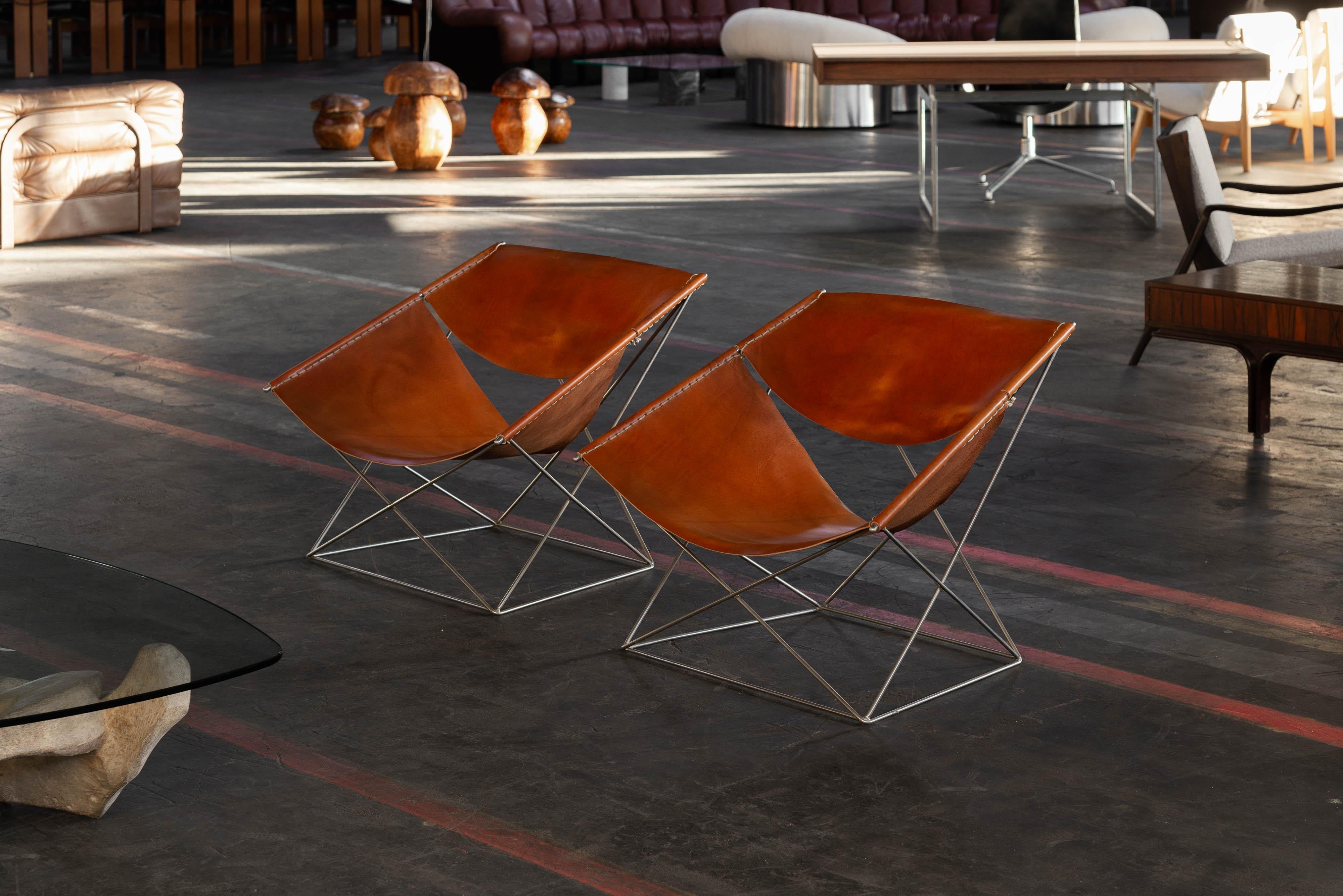 Striking pair of model F675 chairs designed by Pierre Paulin and manufactured by Artifort, The Netherlands 1963. These chairs have nickel-plated geometric frames that are visually stunning! The minimalistic frames against the rich and thick cognac