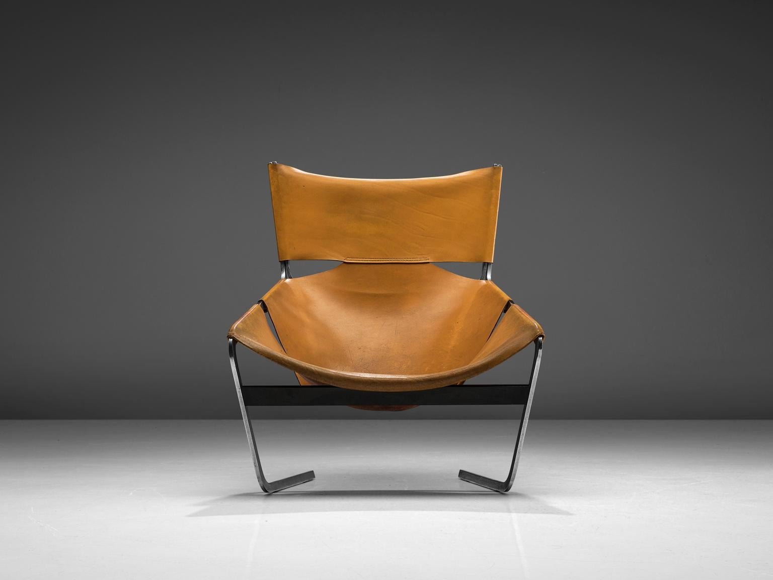 Pierre Paulin for Artifort, F-444 easy chair, metal and cognac leather, the Netherlands, circa 1962.

This cognac leather F-444 chair is designed by Pierre Paulin for Artifort in 1962. This chair shows sharp lines and an angled open seat that