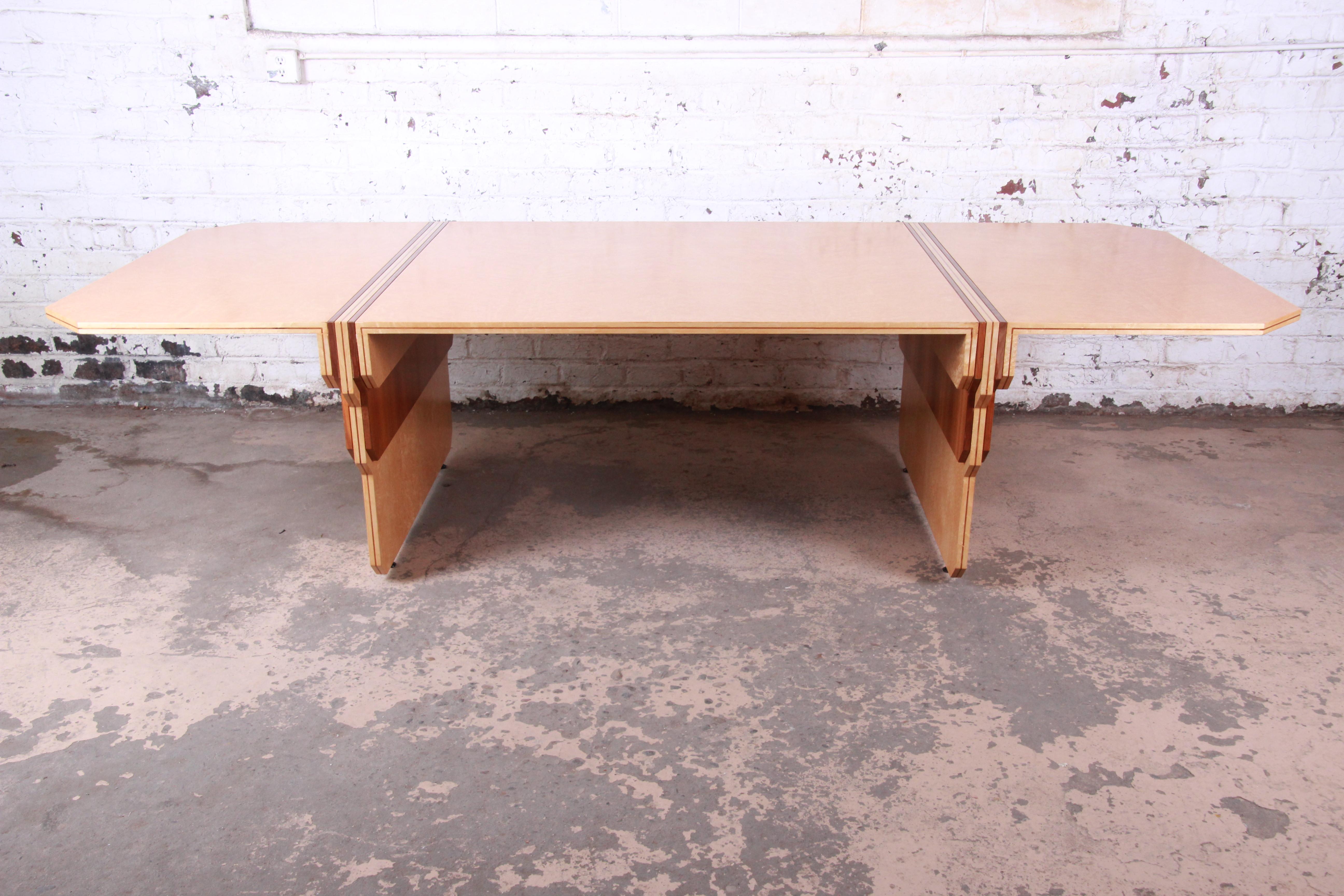 An extremely rare and exceptional Art Deco conference or dining table designed in 1984 by Pierre Paulin for Baker Furniture. The table features gorgeous bird's-eye maple wood grain with walnut inlays in the signature motif for the Paulin Collection.