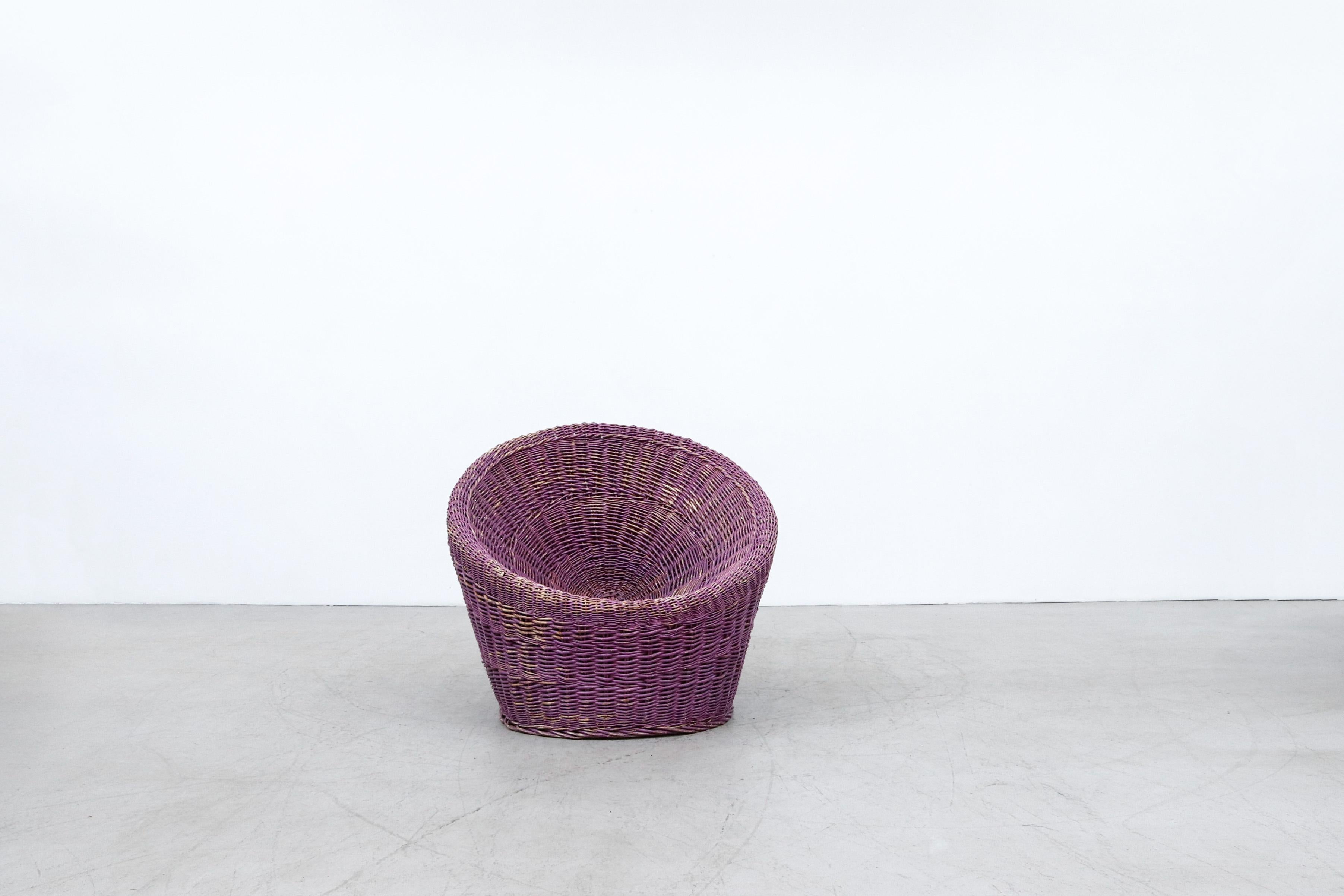 Pierre Paulin inspired Boysenberry Rattan basket chair. In original condition, wear is consistent with age and use.