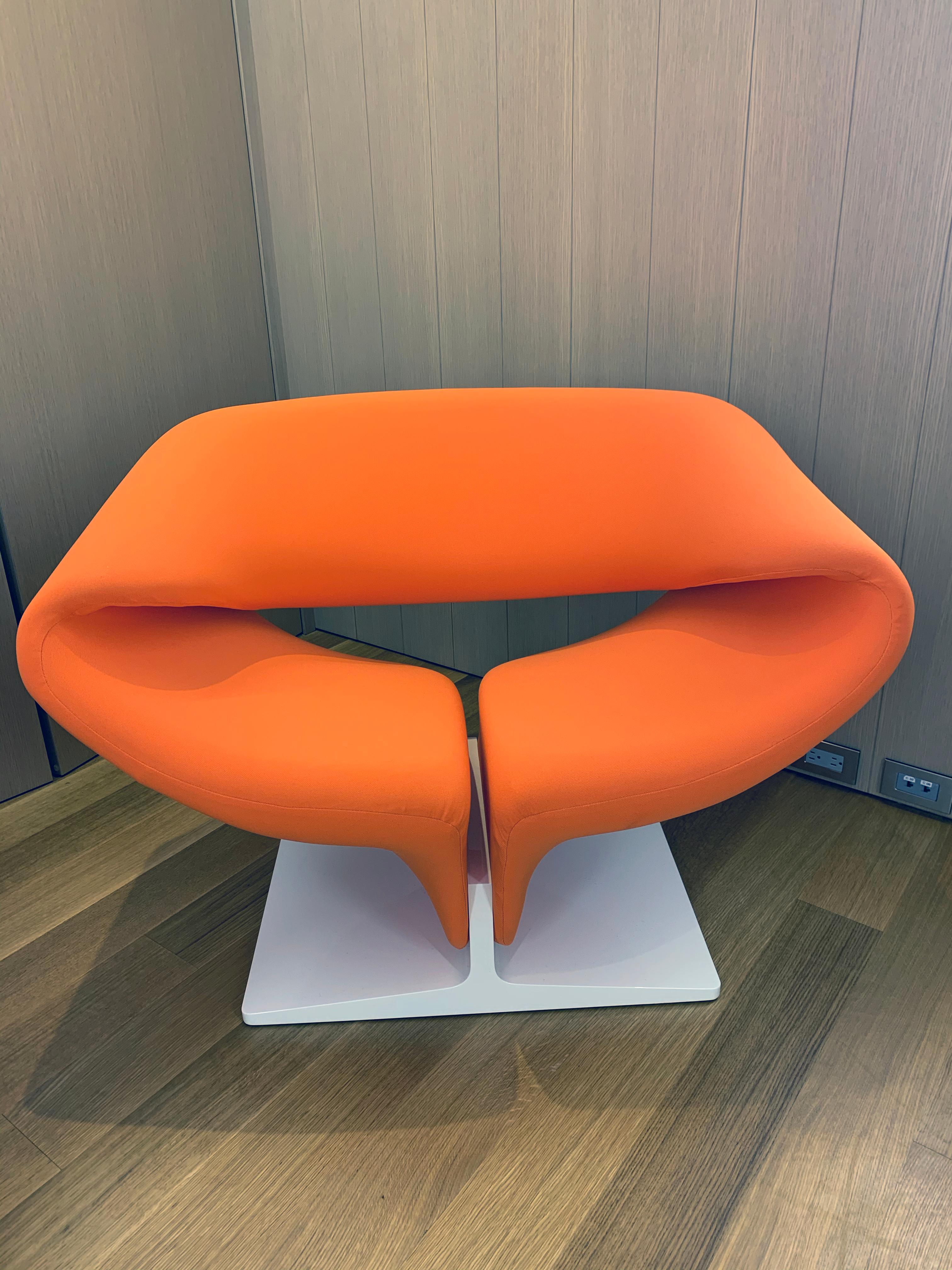 A completely upholstered design by Pierre Paulin from 1966 and a professional, innovative vision on the well-known ribbon form. Metal frame with horizontal springs, covered with foam and stretch fabric. A lacquered pressed-wood pedestal. A beautiful