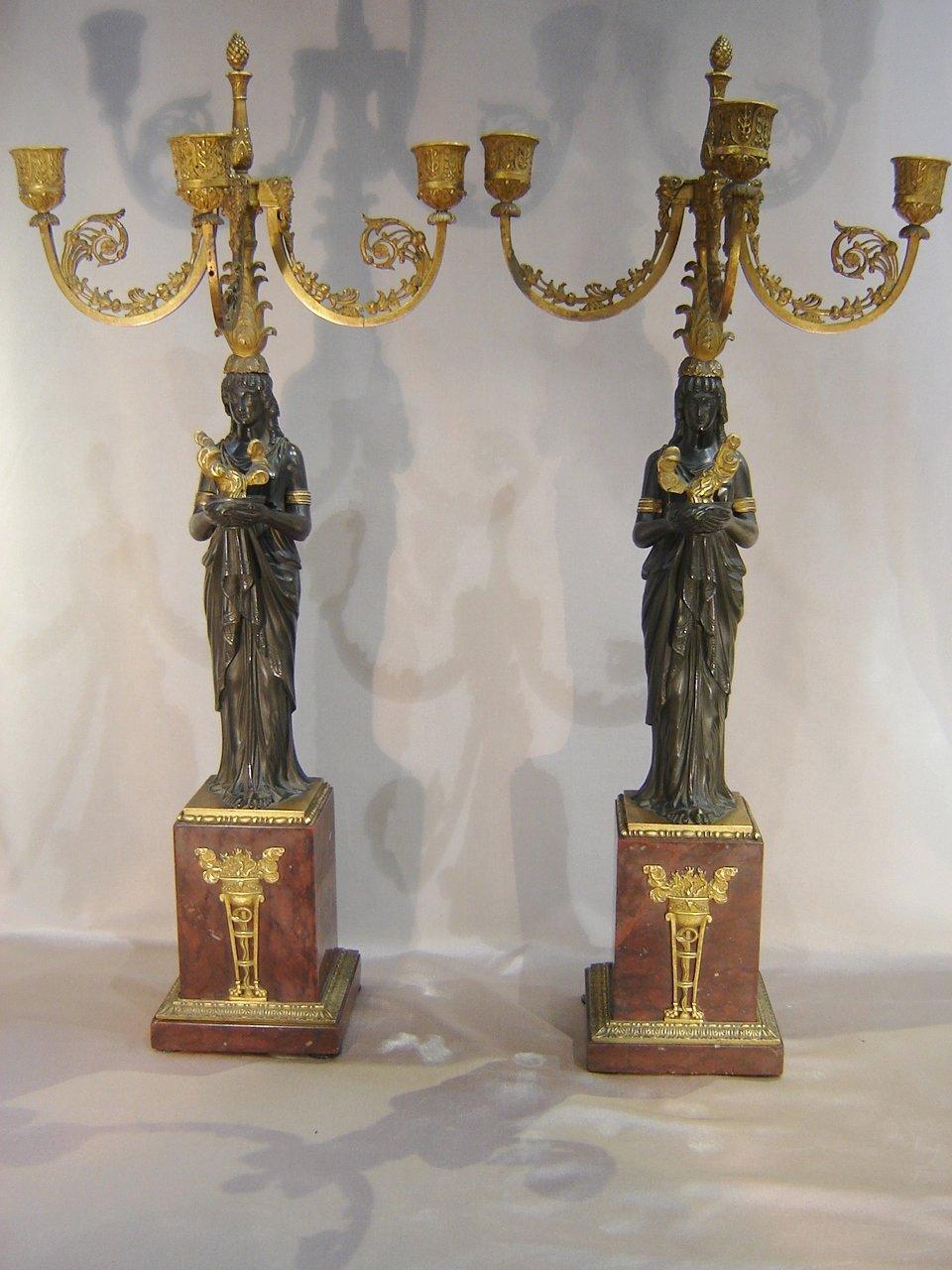 Exceptional pair of patinated bronze and gilded bronze candelabra, dating from the early nineteenth century, Empire period, attributed to Pierre-Philippe Thomire (1751-1843), representing a vestal draped in the antique, holding in his hands a cup of