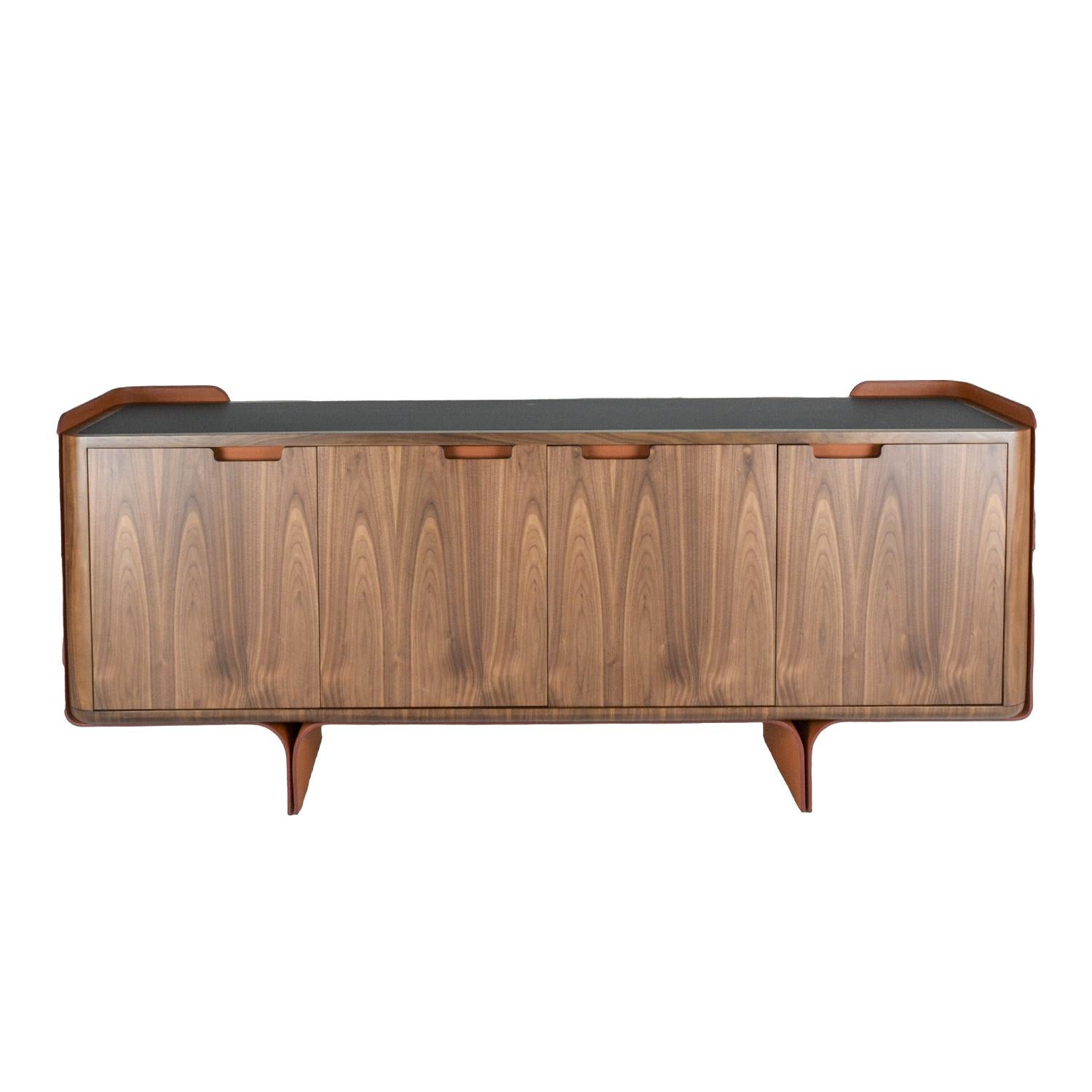 The strong wood body of this sideboard is suspended in the air by a base of bent leather “slabs” that reveal the true craftsmanship of leather in a poetic way. Pierre adds character into a common piece of furniture by taking details that make a