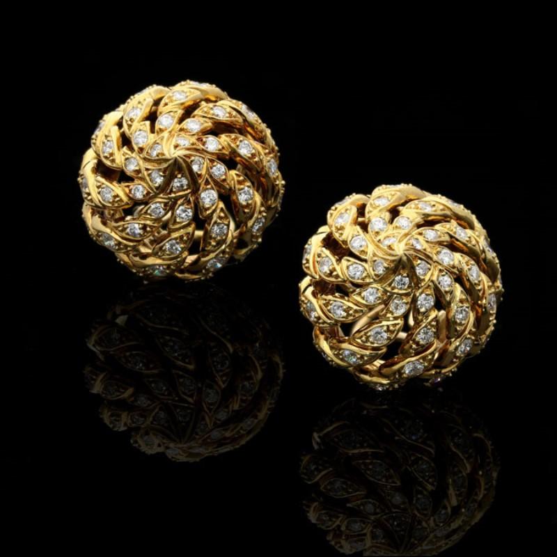 A stylish pair of 18ct yellow gold and diamond earrings by Pierre Sterlé c.irca 1970s, designed as an open work domed spiral set throughout with round brilliant cut diamonds to clip fittings. 

90 round brilliant cut diamonds estimated to weigh a