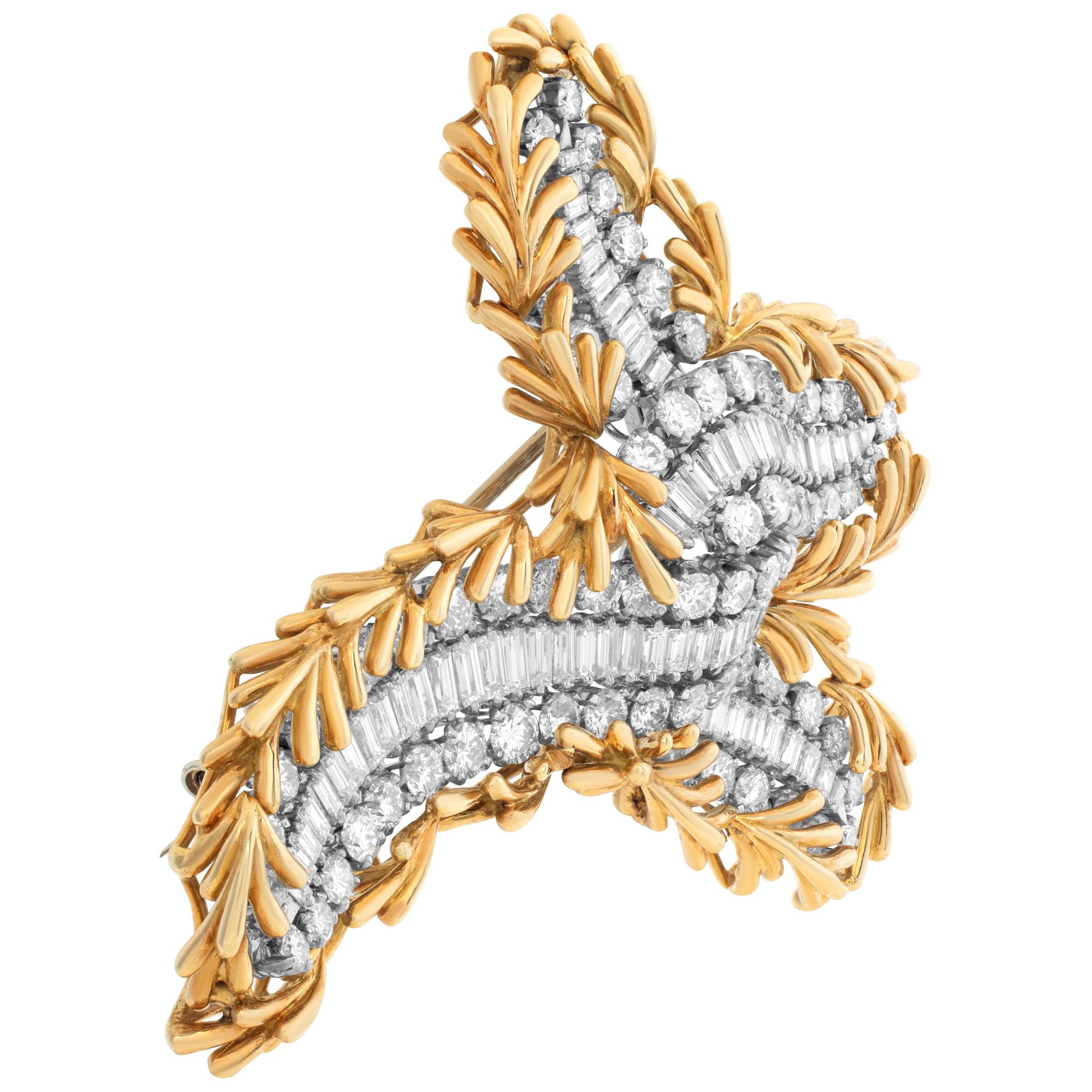 French, mid 20th century diamonds, platinum & 18K yellow gold brooch by Pierre Sterle Paris (1905-1978). This brooch is made in a dimensional stylized bow motif with a decorated edge of 18K gold twiggs. Center baguettes & brilliant round cut