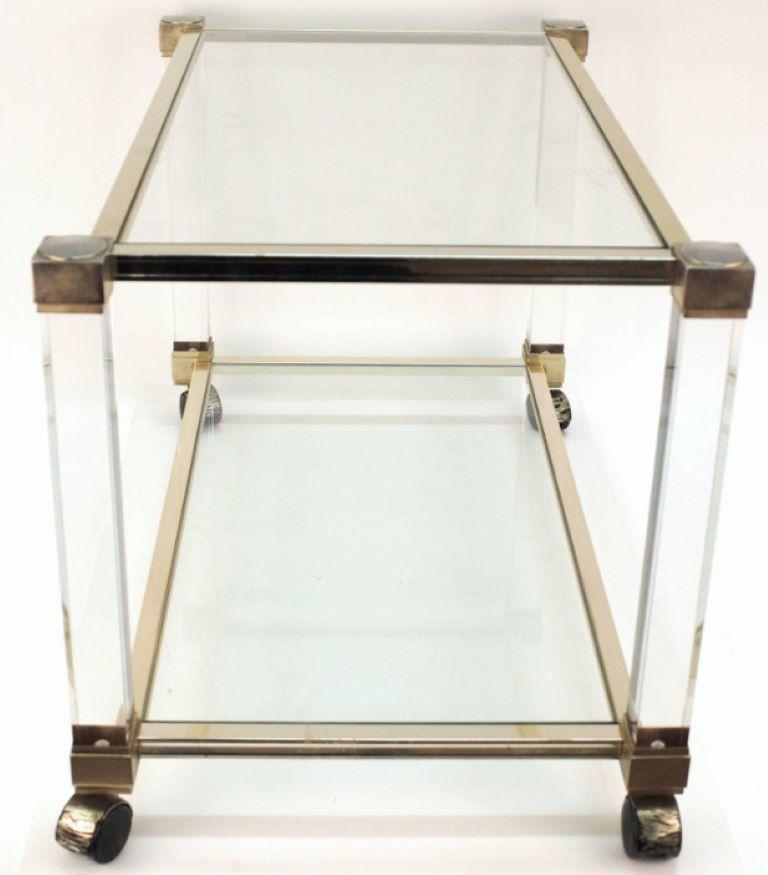 Pierre Vandel bar cart on casters with glass shelves, Lucite frame and chrome accents. The bar cart has two shelves and has a label that reads 'Pierre Vandel Paris.'

Dealer: S138XX