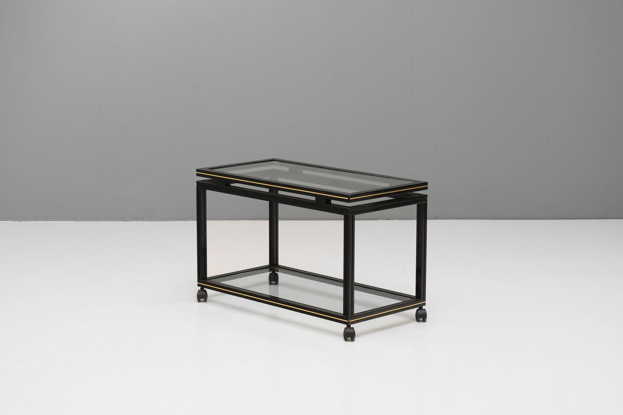 Two tier drinks trolley in black by Pierre Vandel. France circa 1970.
H 50cm x W 80cm x D 40cm