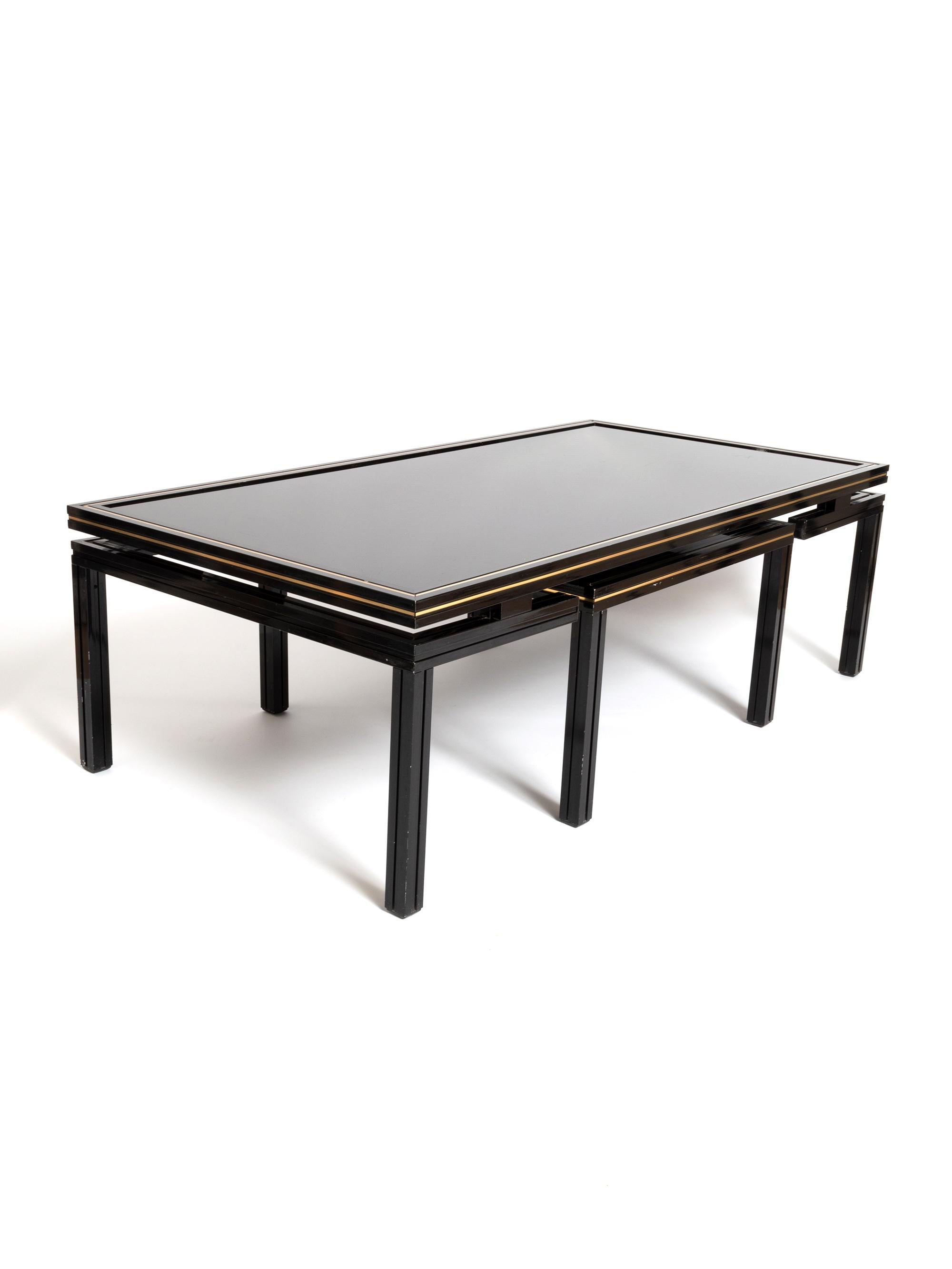Pierre Vandel Paris black lacquer coffee table with nesting table. France, circa 1970.
In very good vintage condition with minor signs of wear.

Dimensions:
Coffee table
Length 105.5cm
Depth 54.5cm
Height 33cm

Nesting table
Length