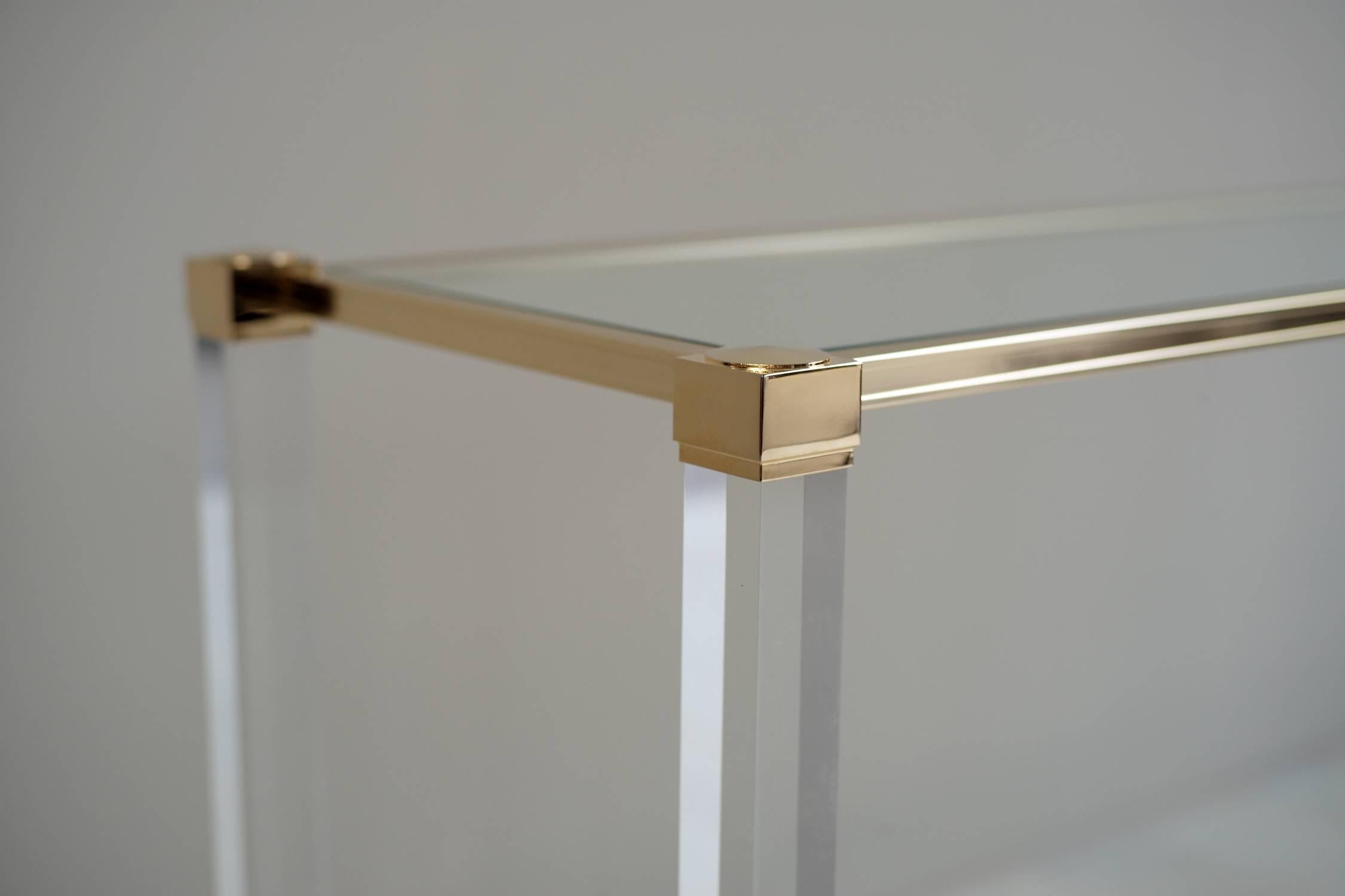 Console in plexiglass, gilt metal and glass Pierre Vandel, France 1980.
Brand new condition, signed on the top banner.
After a collaboration with the company Marais International, Pierre Vandel with the support of Pierre Cardin created his own
