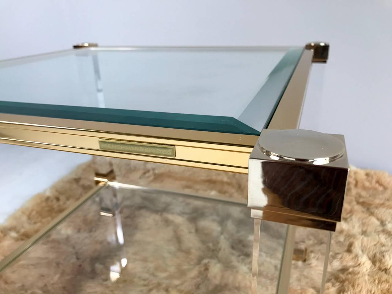 Pair of tables in plexiglass, glass and gold metal double tray signed on the upper band PIerre Vandel Paris, France, 1970.
New state of origin.

After a collaboration with the Company Marais International, Pierre Vandel, with the support of