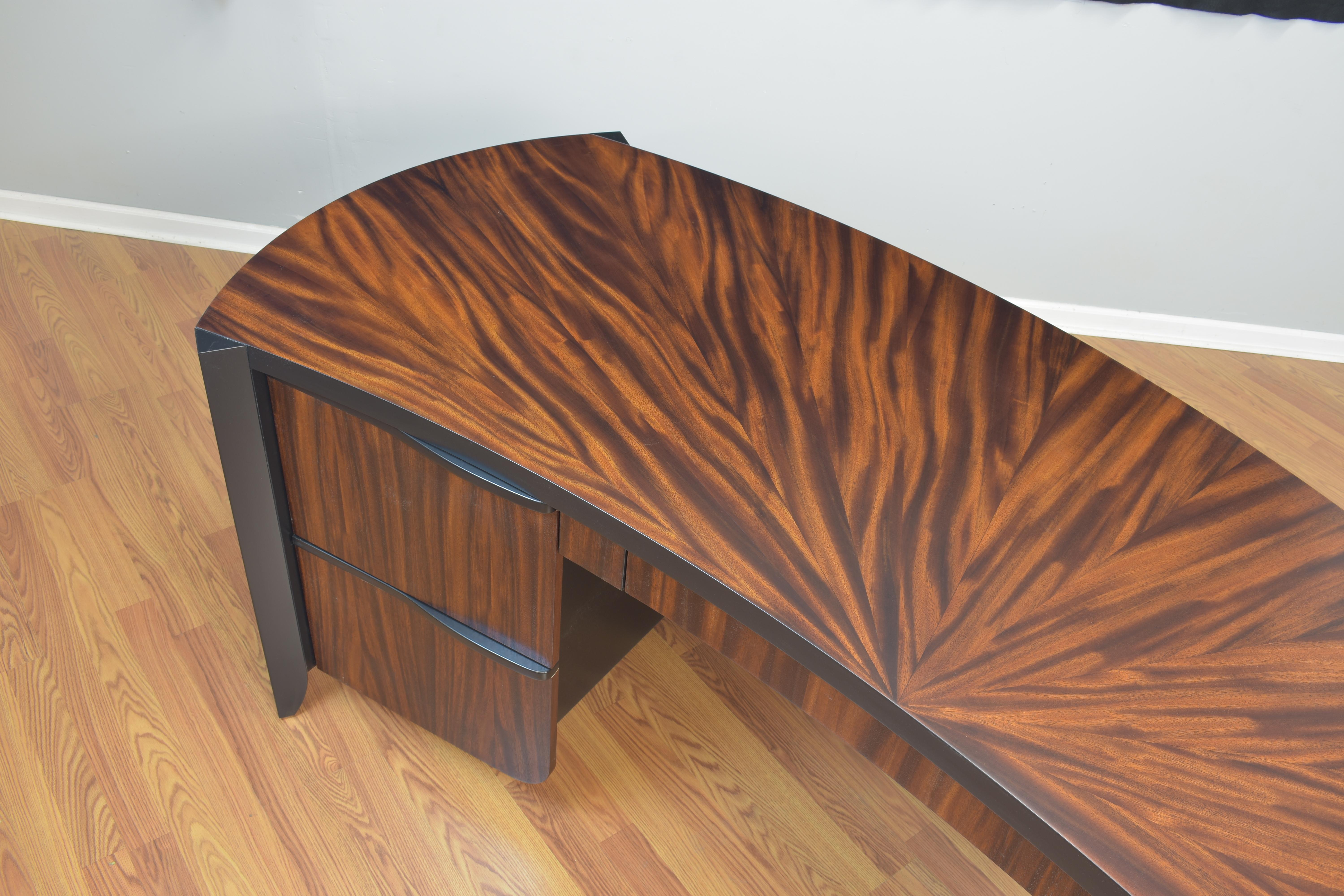 The Pierre desk features monkey Pod veneer from Hawaii. It has a starburst veneer pattern on the top. It has two file drawers and a pencil drawer. The hand sculpted wood drawer handles are finished in a jet black lacquer.

All our work is