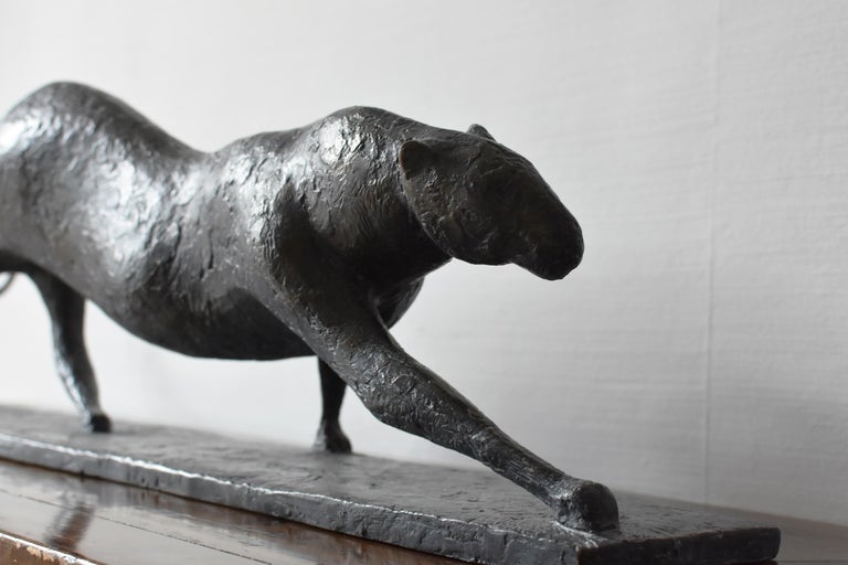 Feline IV is a bronze sculpture by French contemporary artist Pierre Yermia which represents a walking feline (a leopard, a jaguar or a cheetah). The dark patina with blue shades emphasizes the mysterious elegance of its profile. 
24 cm × 90 cm × 20
