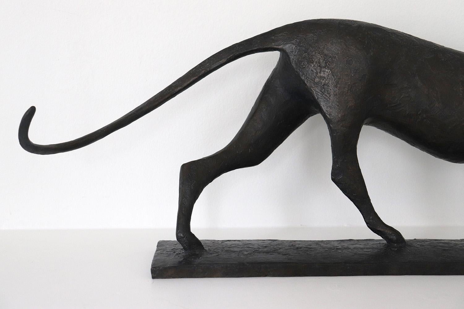 Feline VI is a bronze sculpture by French contemporary artist Pierre Yermia which represents a walking feline (a leopard, a jaguar or a cheetah). The dark patina with blue shades emphasizes the mysterious elegance of its profile. 
29 cm × 83 cm × 15