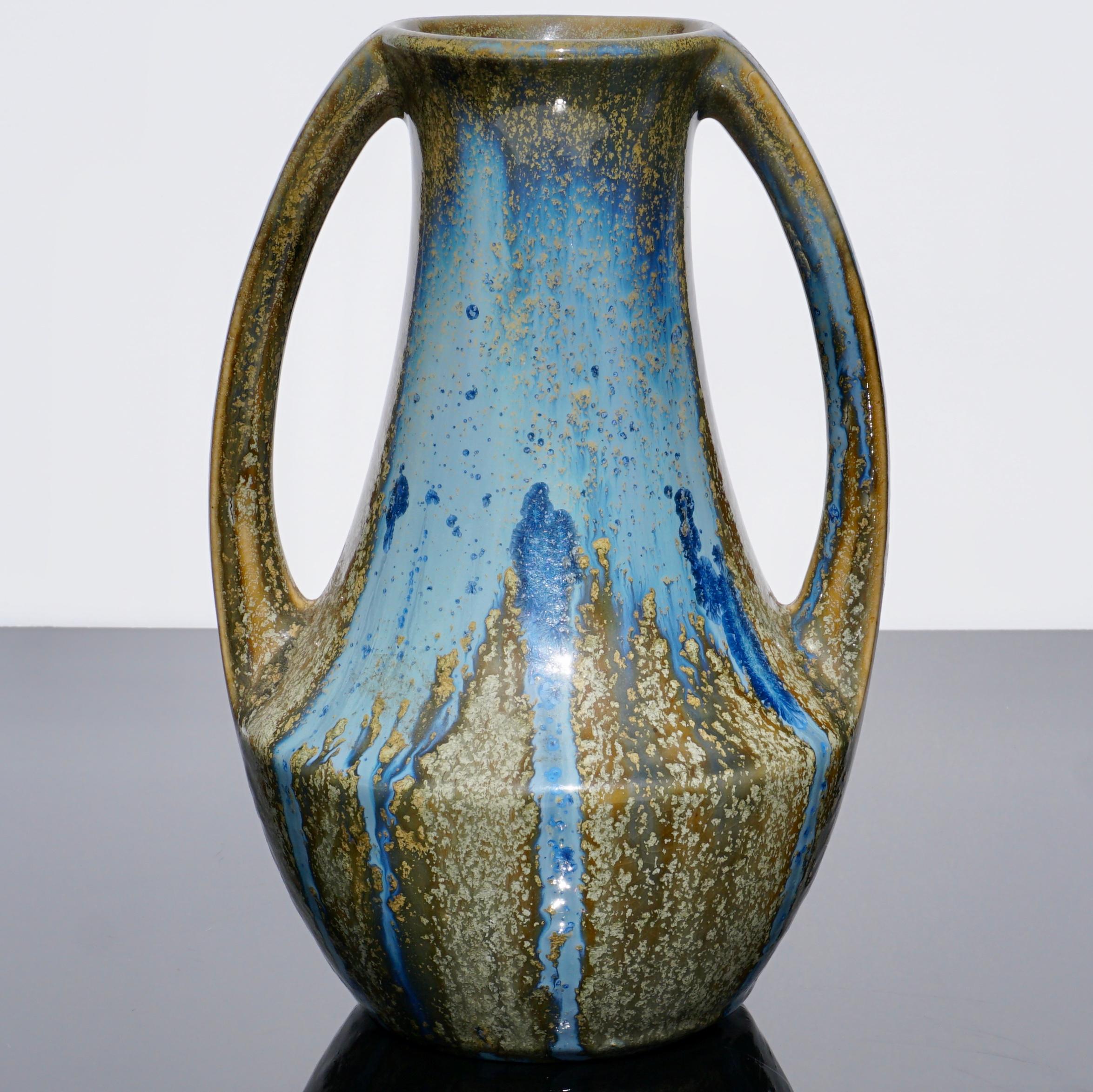 A Pierrefonds (France) Art Nouveau vase with Amphora form and two elegant handles. Glazed with beautiful crystalline star-bursts of light and dark blue on a glistening beige background. Excellent condition!

Measures: Height 9 inches (23