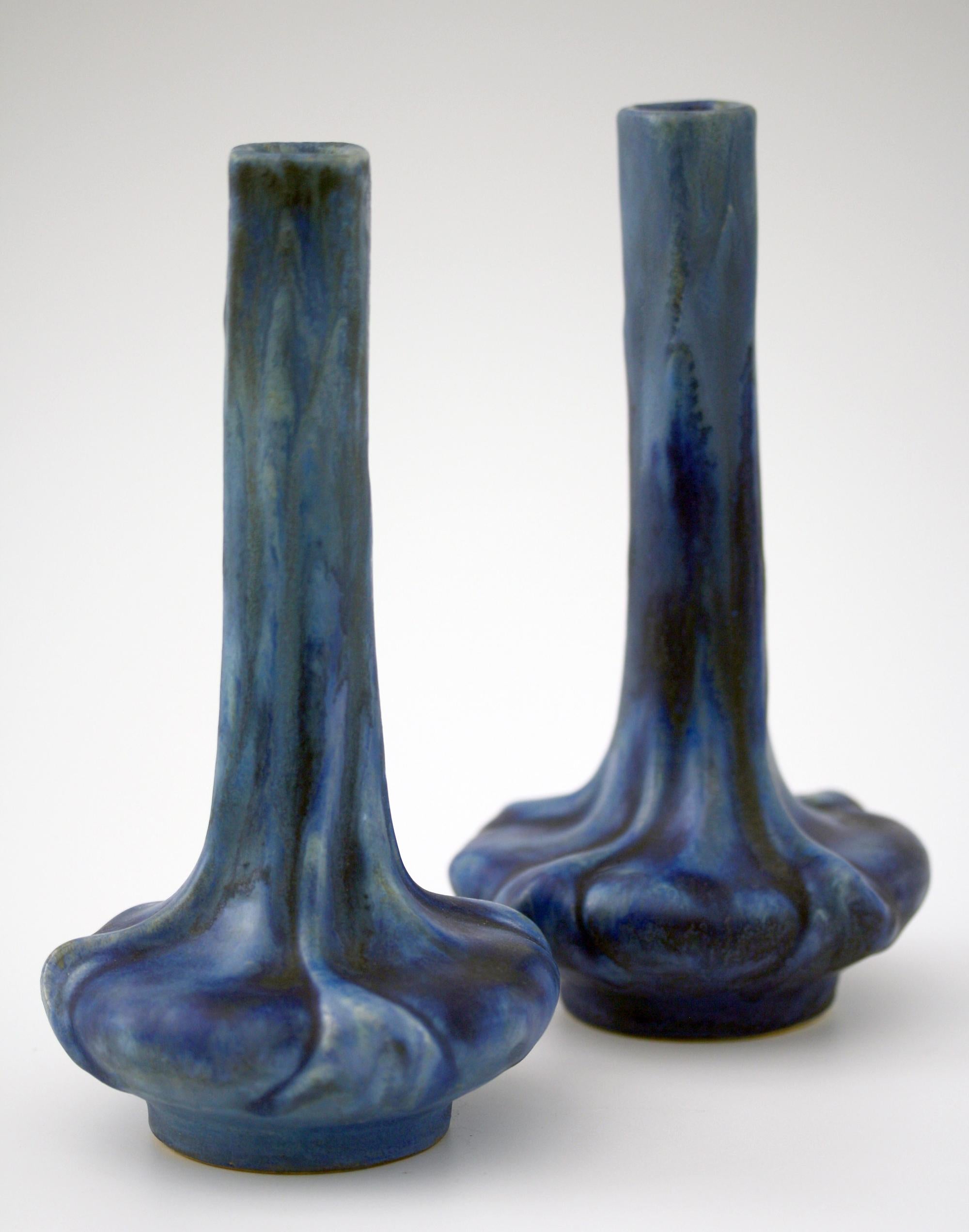A fine pair French Art Nouveau art pottery vases decorated in blue crystalline glazes made at Olivier de Sorra's (Count Hallez d'Arros) Pierrefonds Pottery and dating from circa 1910. The vases stand on a narrow rounded foot with a moulded flower