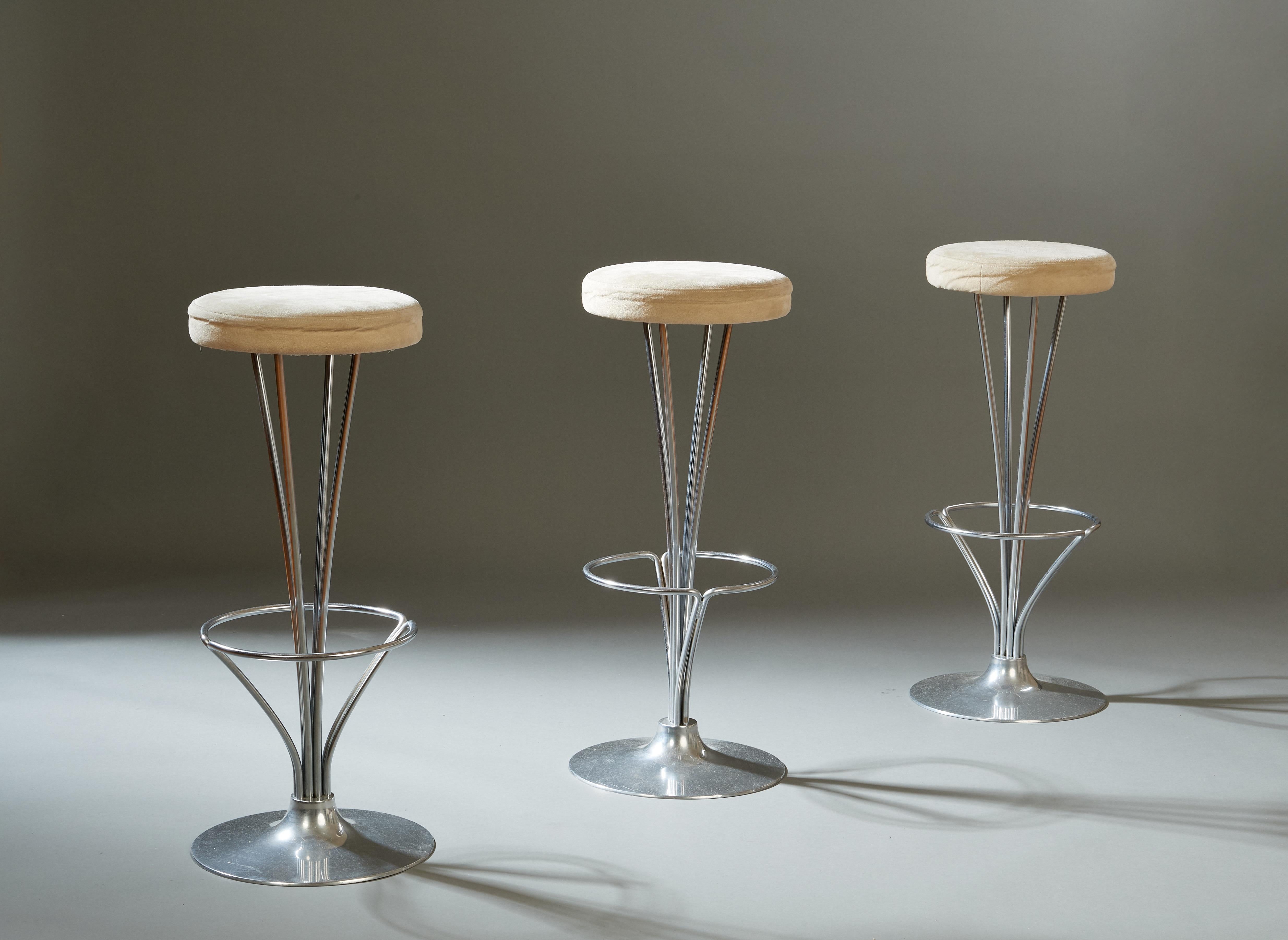 Piet Hein (1905-1996)

A set of three Danish Modern barstools by the poet, philosopher, and mathematician Piet Hein. A base in chromed steel curves outwards to support a comfortable seat in tan suede, which rises above a practical and elegant