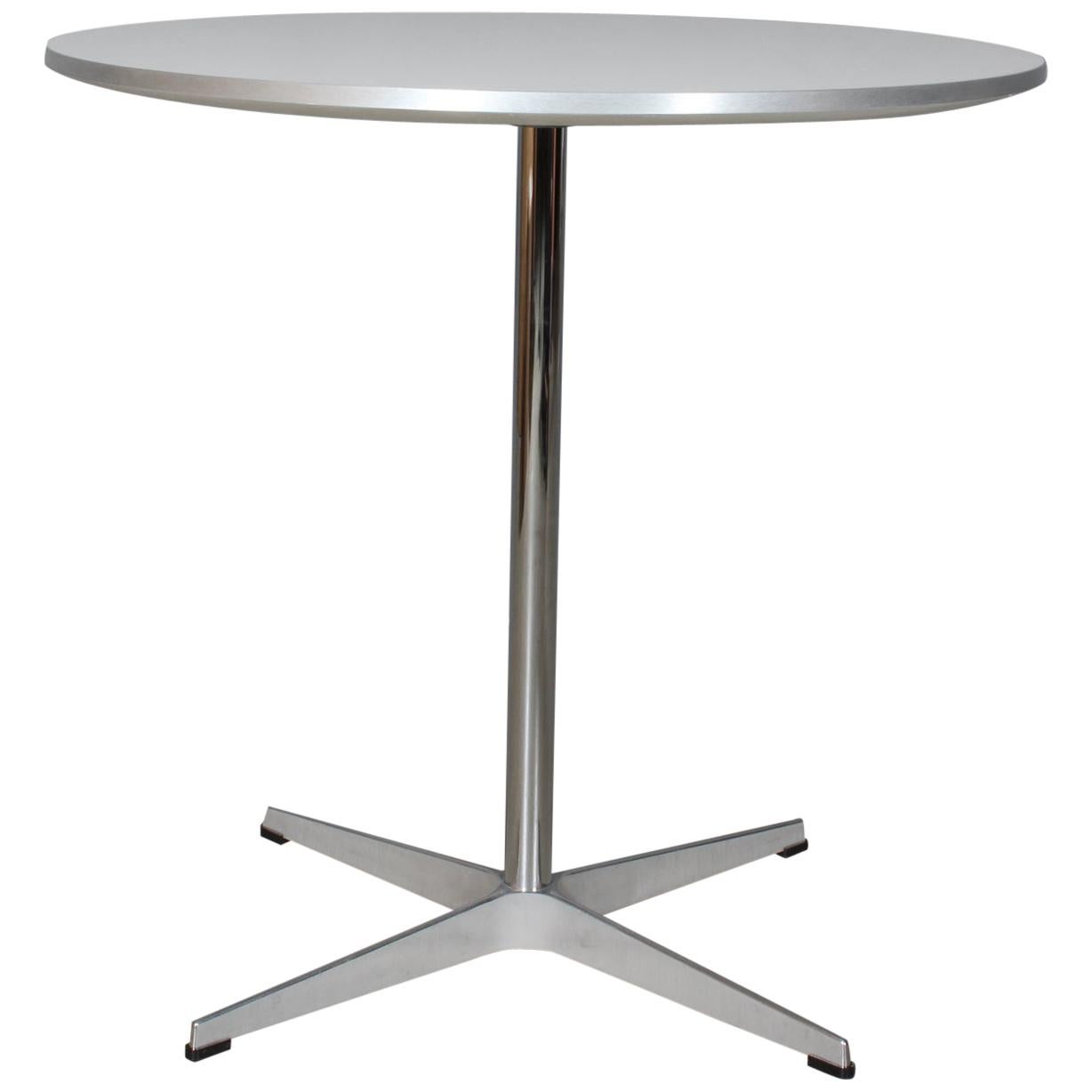 Piet Hein & Arne Jacobsen café / kitchen table with plate of laminate and aluminium side.

Four star base of aluminium and steel.

Made by Fritz Hansen.