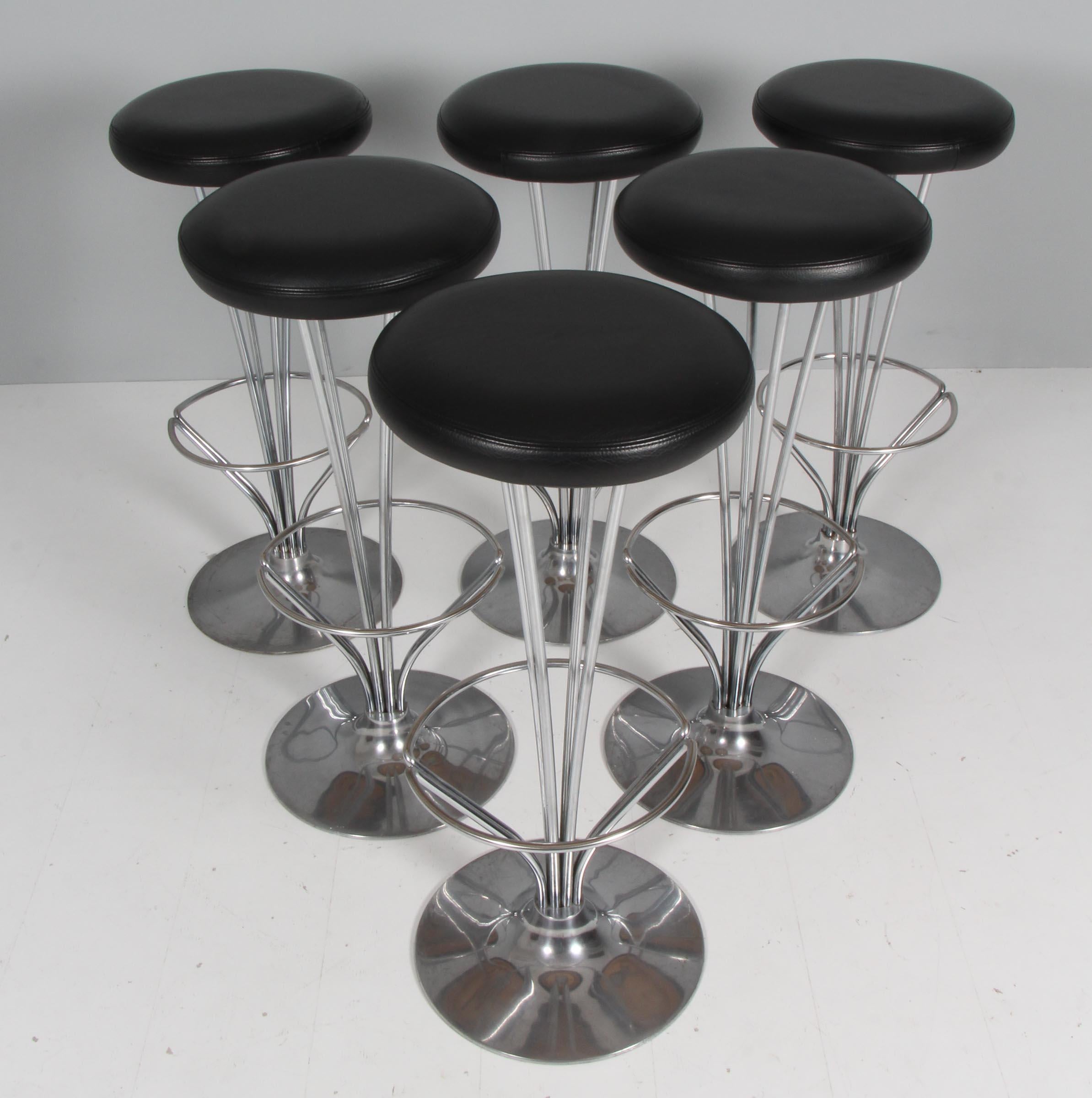 Piet Hein bar stools original upholstered with black leather.

Made by Fritz Hansen.