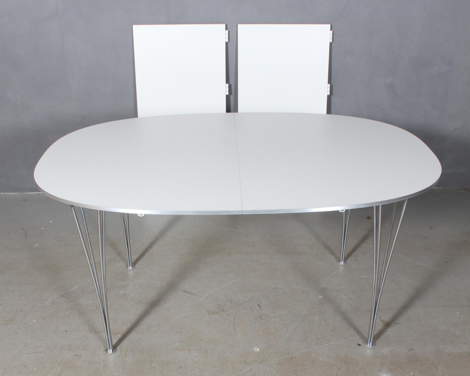 Piet Hein & Bruno Mathsson dining table with original white laminate.

Alu side list.

Two extension leaf of 50 cms.

Legs of chromed metal.

Model Super Elipse, made by Fritz Hansen.

This is one of the most iconic tables in Scandinavia.
