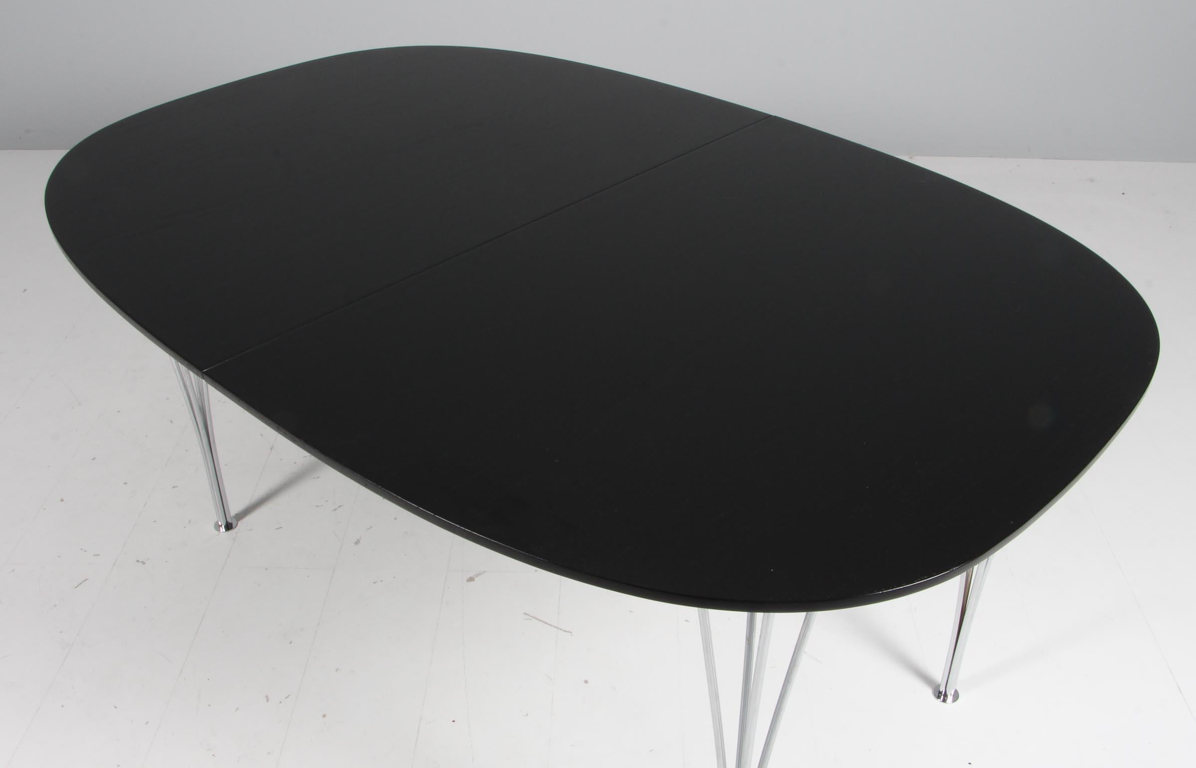 Piet Hein & Bruno Mathsson ellipse dining table in black stained oak veener, two extension leafes.

Legs in chromed steel.

Made by Fritz Hansen.
 