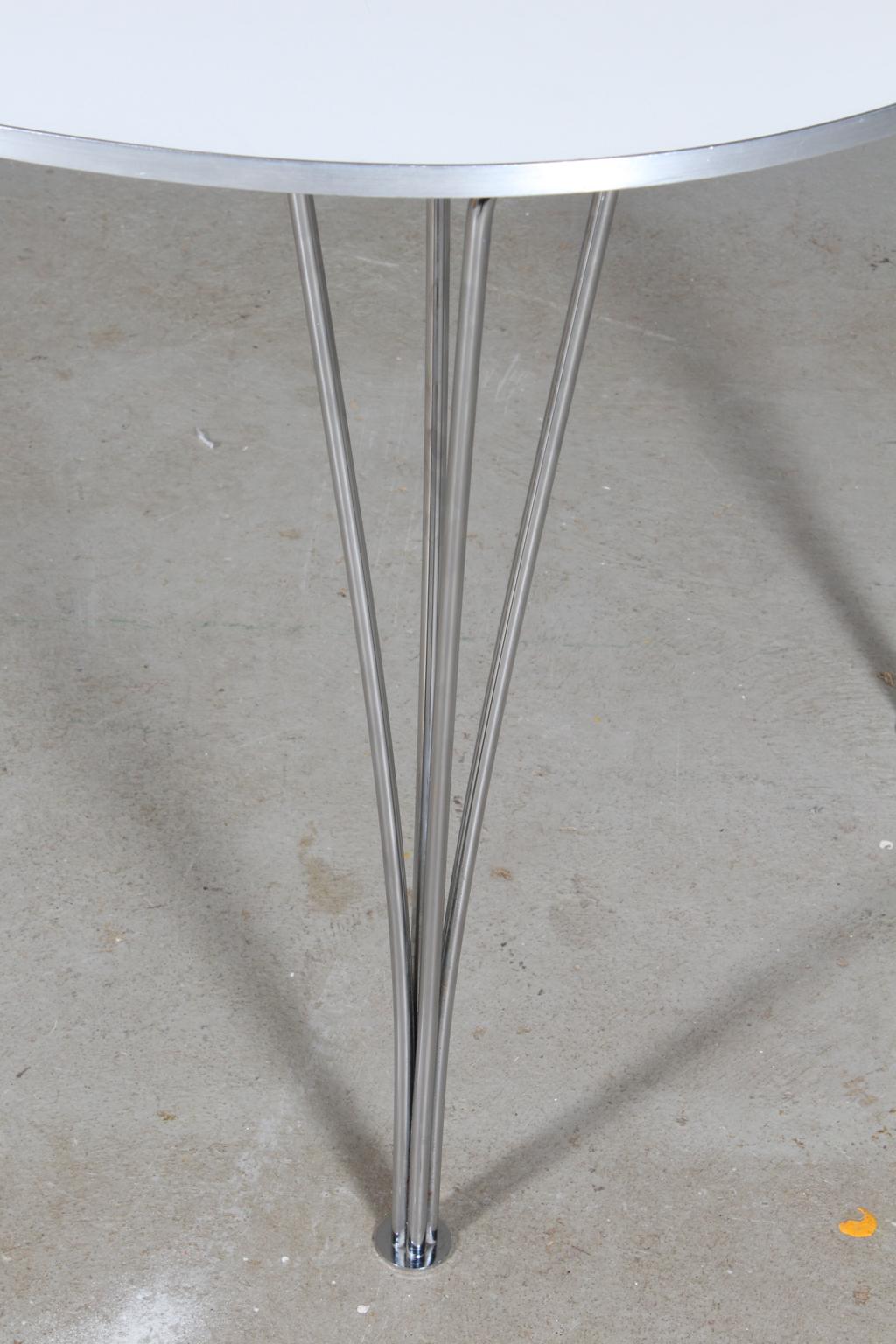 Piet Hein & Bruno Mathsson ellipse dining table white laminate. Alu list on the side.

Legs in chromed steel.

Made by Fritz Hansen 1998.
  