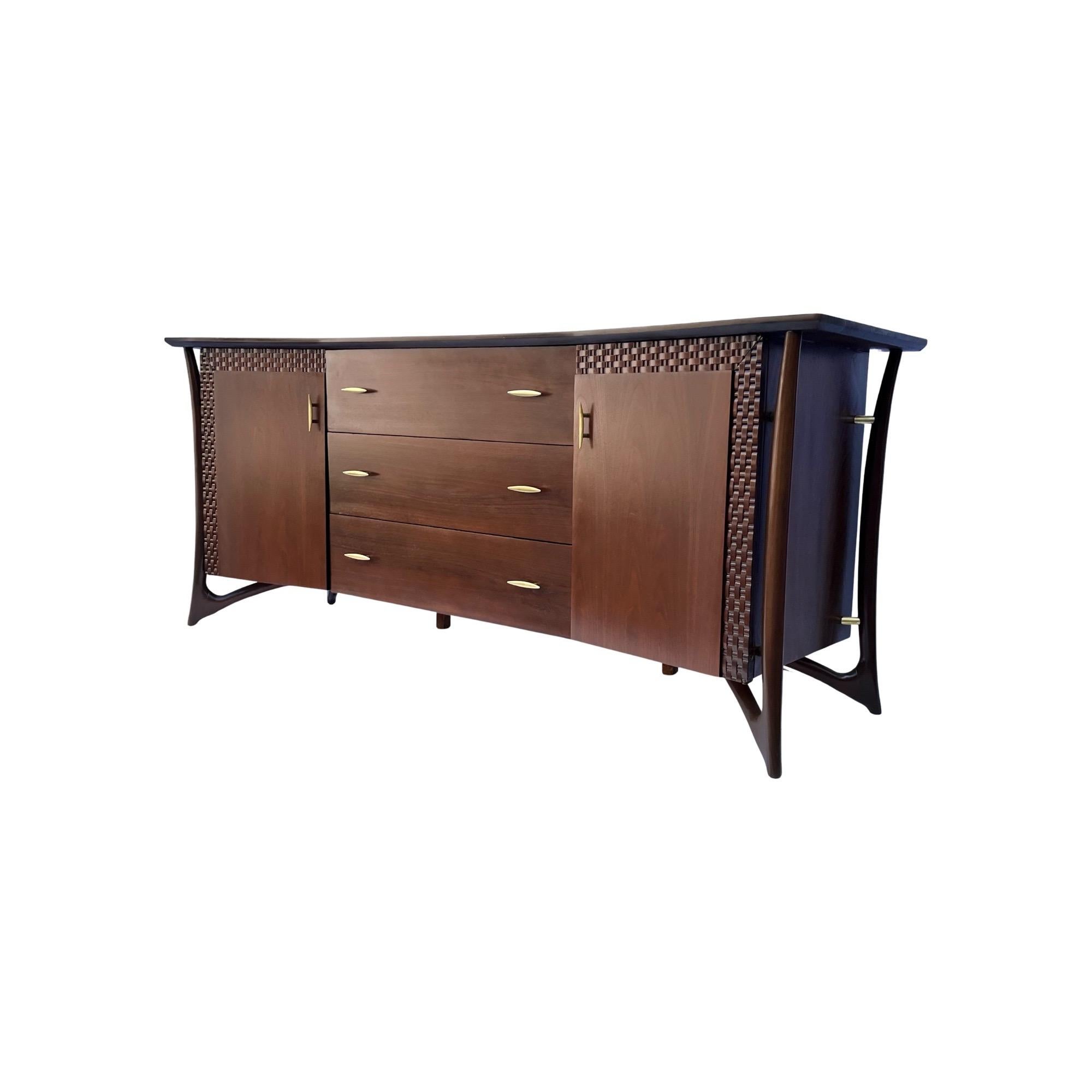 Introducing a captivating piece of furniture from the late 1950s, behold this magnificent walnut and brass dresser by the renowned designer Piet Hein. Crafted with meticulous attention to detail, this sculptural masterpiece showcases hand-formed
