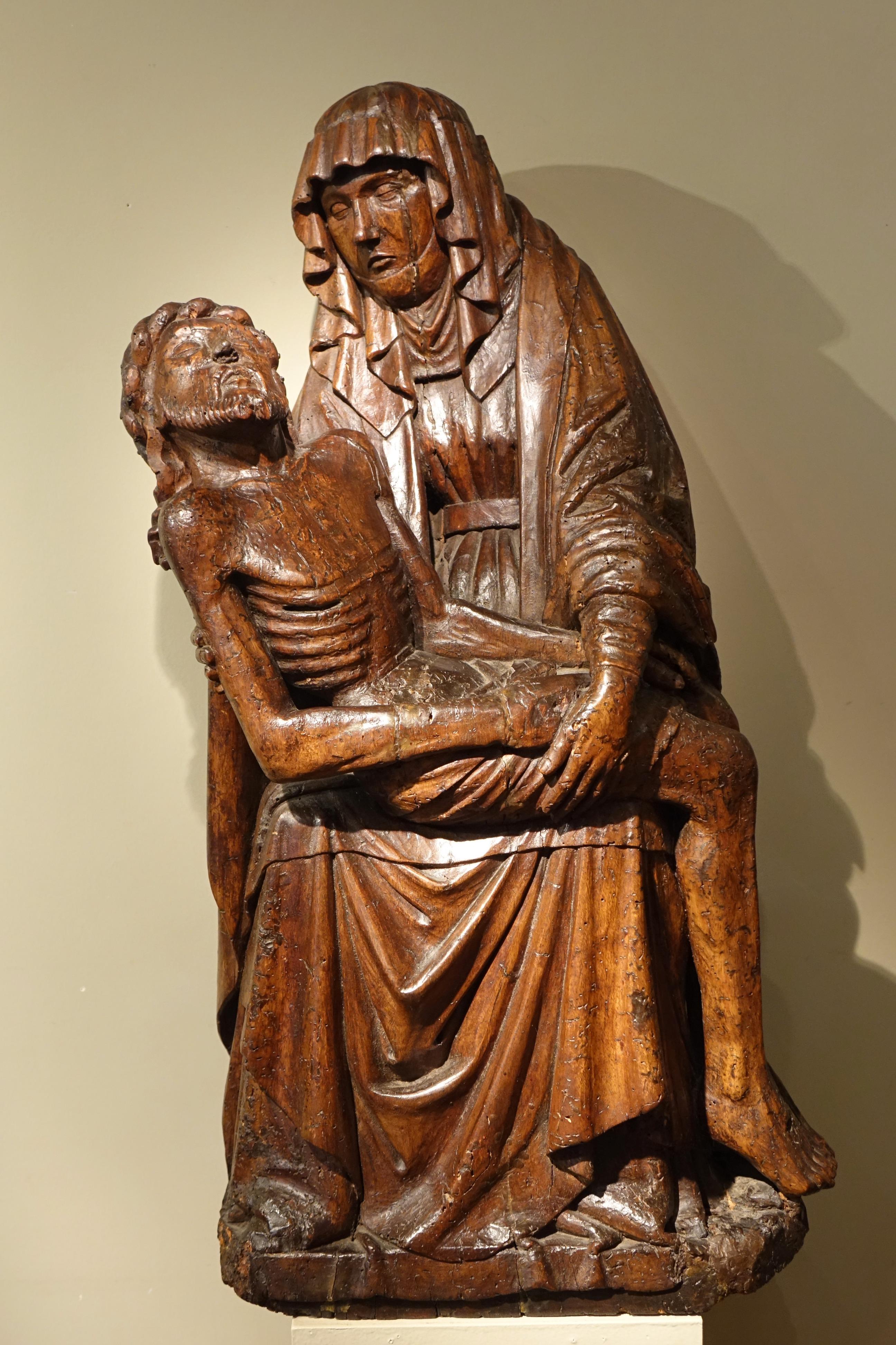 Beautiful and large Pieta, carved in the round in oak.
Mary holds Jesus' body on her knees as he descends from the cross, after his crucifixion and before his burial.
This theme of suffering and death is the first in the order of events after the