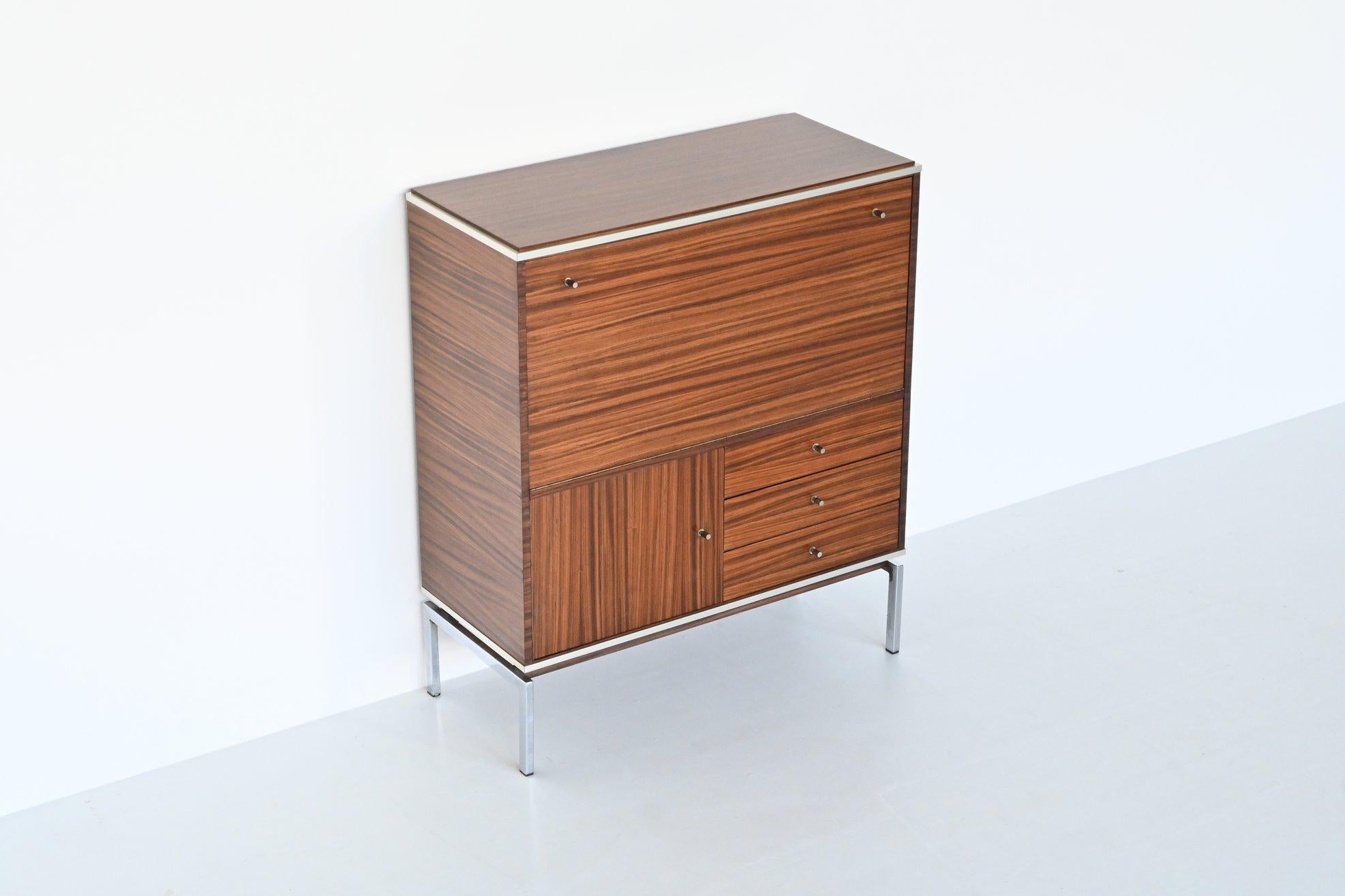 Beautiful buffet or bar cabinet designed by Pieter de Bruyne for AL Meubel, Belgium 1960.  This very nice slim shaped cabinet is made of dark grained rosewood supported by chromed steel legs. Even the inside door panels are beautiful flamed. The