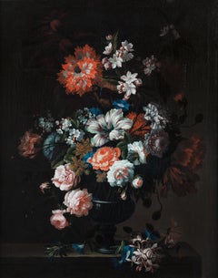 Roses, tulips, carnations and other flowers in a glass vase, with honeysuckle