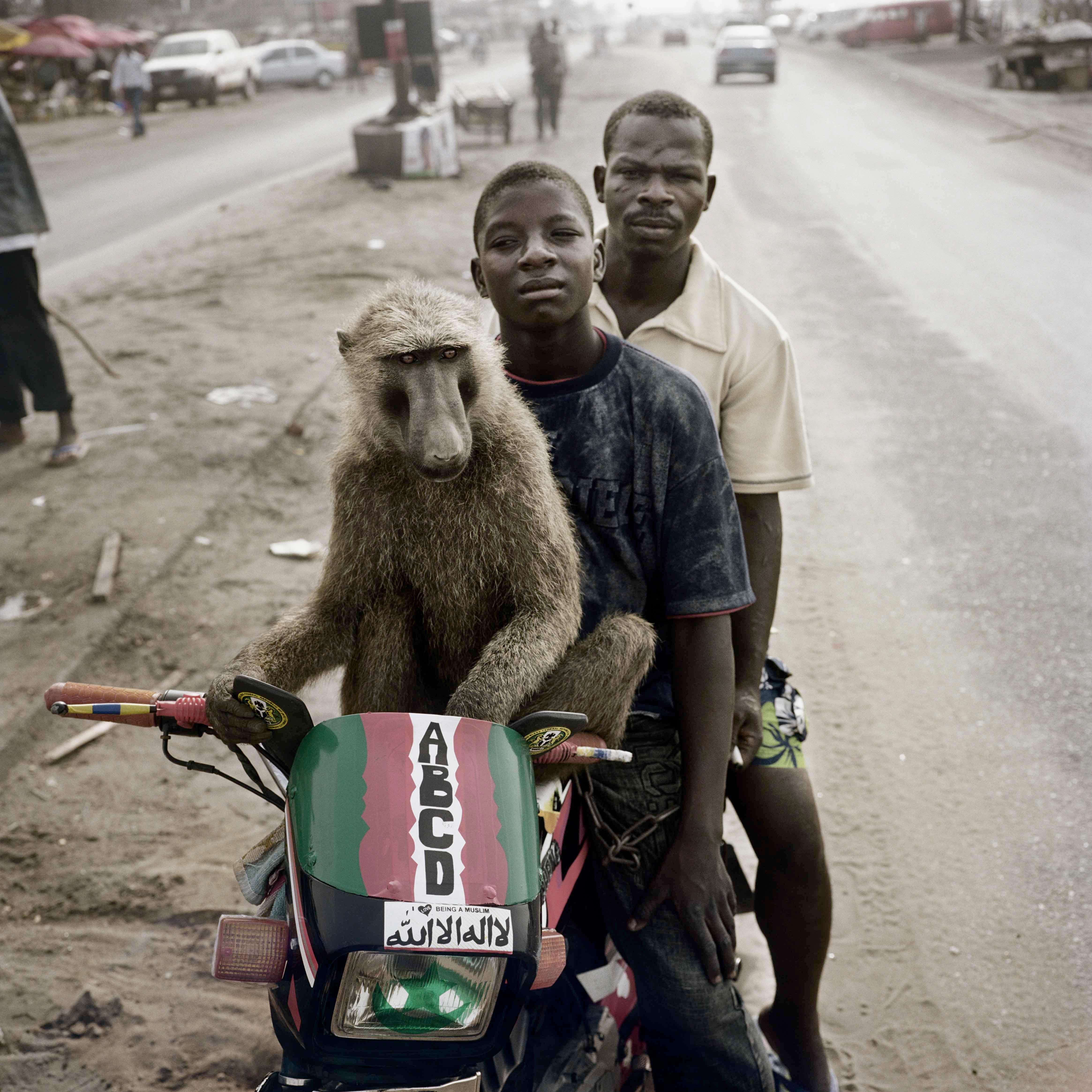 Emeka, Motorcyclist and Abdullahi Ahmadu, Asaba, Nigeria, 2007 - Pieter Hugo
Signed on reverse
Digital c-type print
39 1/4 x 39 1/4 inches
From an edition of 9 + 2 APs

Pieter Hugo (born 1976) is a South African artist who, through his large format