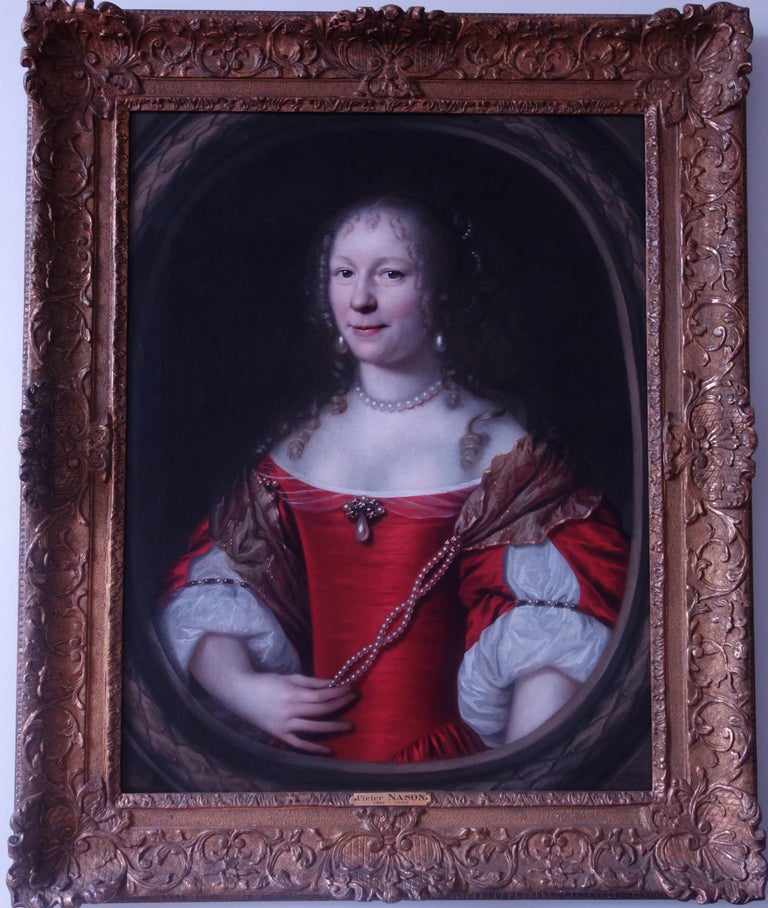 Portrait of a lady, half-length in a feigned oval wearing a ruby coloured dress holding twisted pearls across her bodice. Signed 'PNason' and dated 1667 (lower right). Oil on canvas in a period giltwood frame,.

Dimensions: 86.2 x 66.7cm (34 x 26