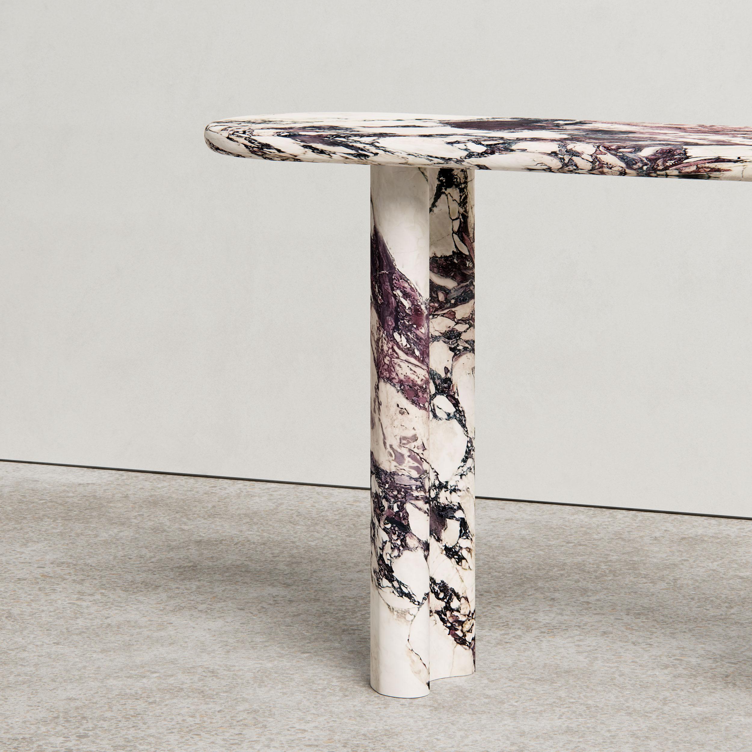 The Pietra Console Designed by Just Adele. This design is carved from a single block of Italian natural stone to create organic curves with a bullnose edge and kidney-shaped legs. 

Available in Viola Monet and Travertine, with bespoke stones