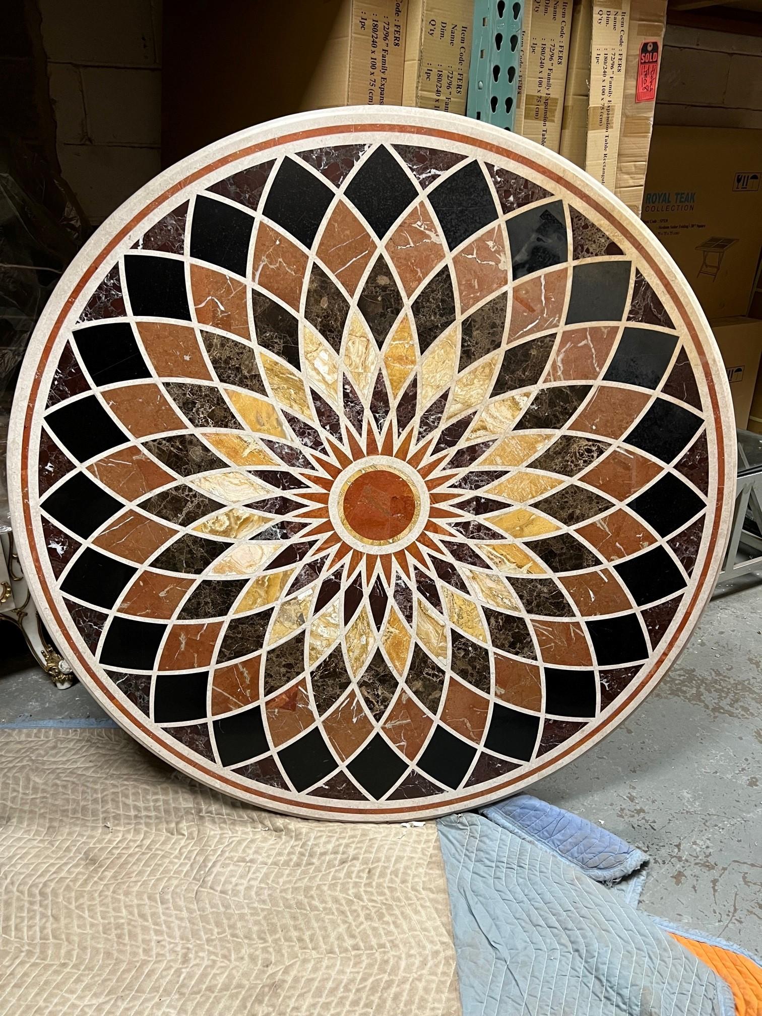 Beautiful Pietra Dura round table top with geometric shapes and a warm earth tone color palette.  Pietra Dura (Pietra=Stone, Dura=Hard) is the use of hard stones and semi precious stones in a mosaic. This craft started in Florence Italy in the late
