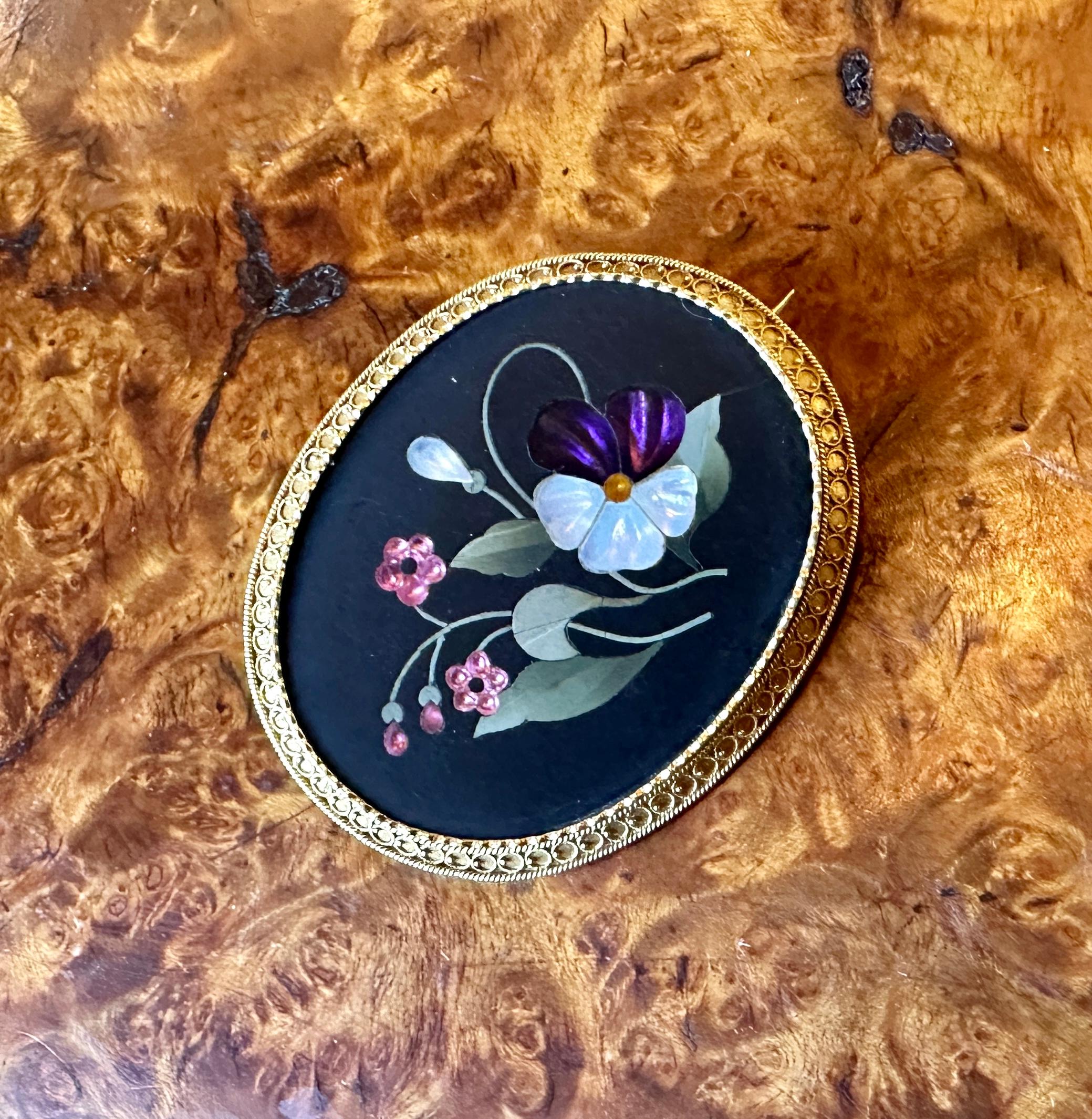 Indulge in a stunning Pietra Dura Brooch in 14 Karat Gold with inlaid semi-precious stones including Amethyst and Mother-of-Pearl, creating an iridescent mosaic image of flowers, including a gorgeous purple and white pansy, and forget-me-nots.  The
