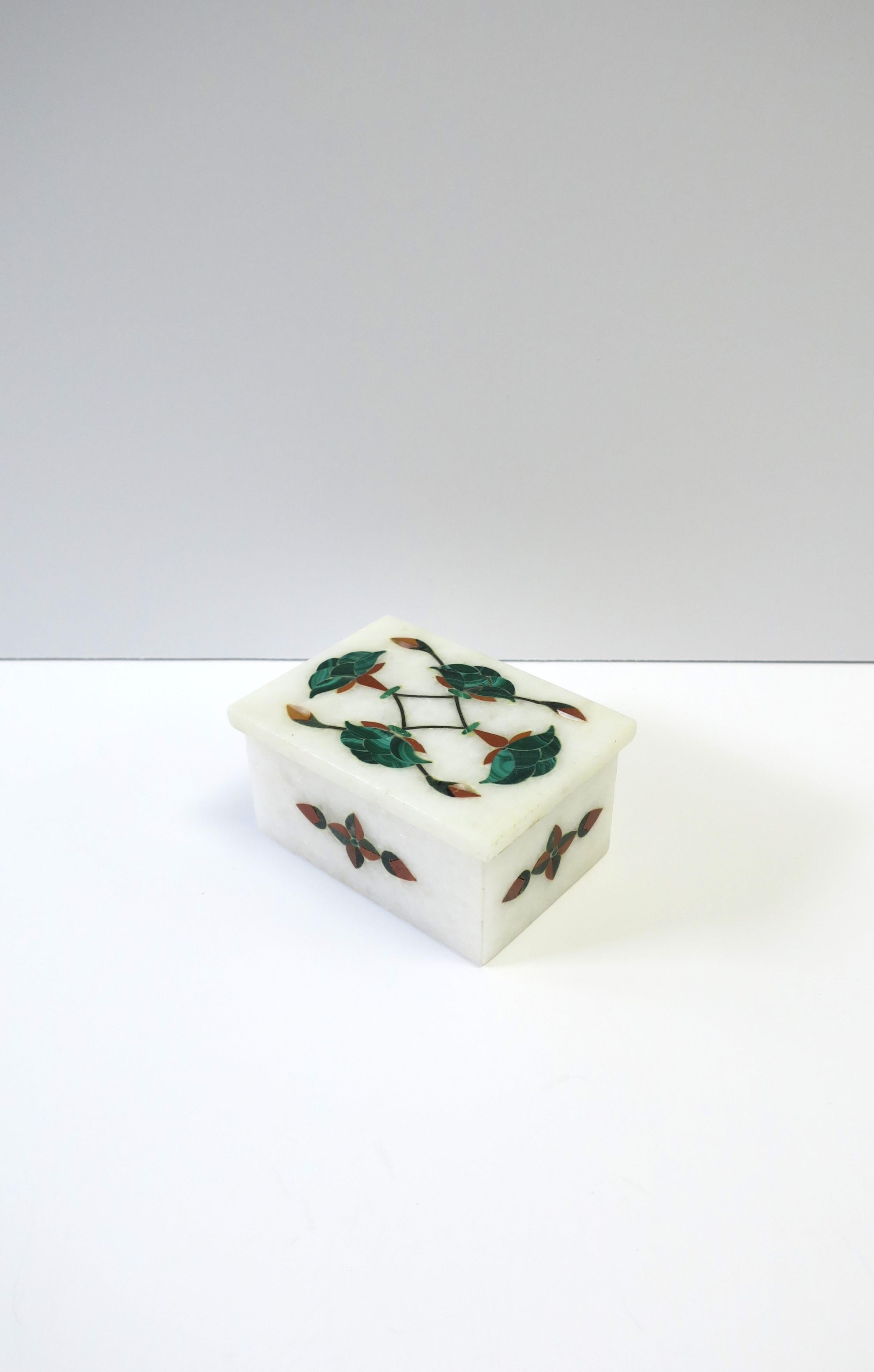 A Pietra Dura green malachite and granite marble stone inlayed decorative or jewelry box, circa 20th century. Box is white granite marble with green malachite and white mother of pearl shell flower and leaf inlayed design. Hand-carved. Hand-crafted.
