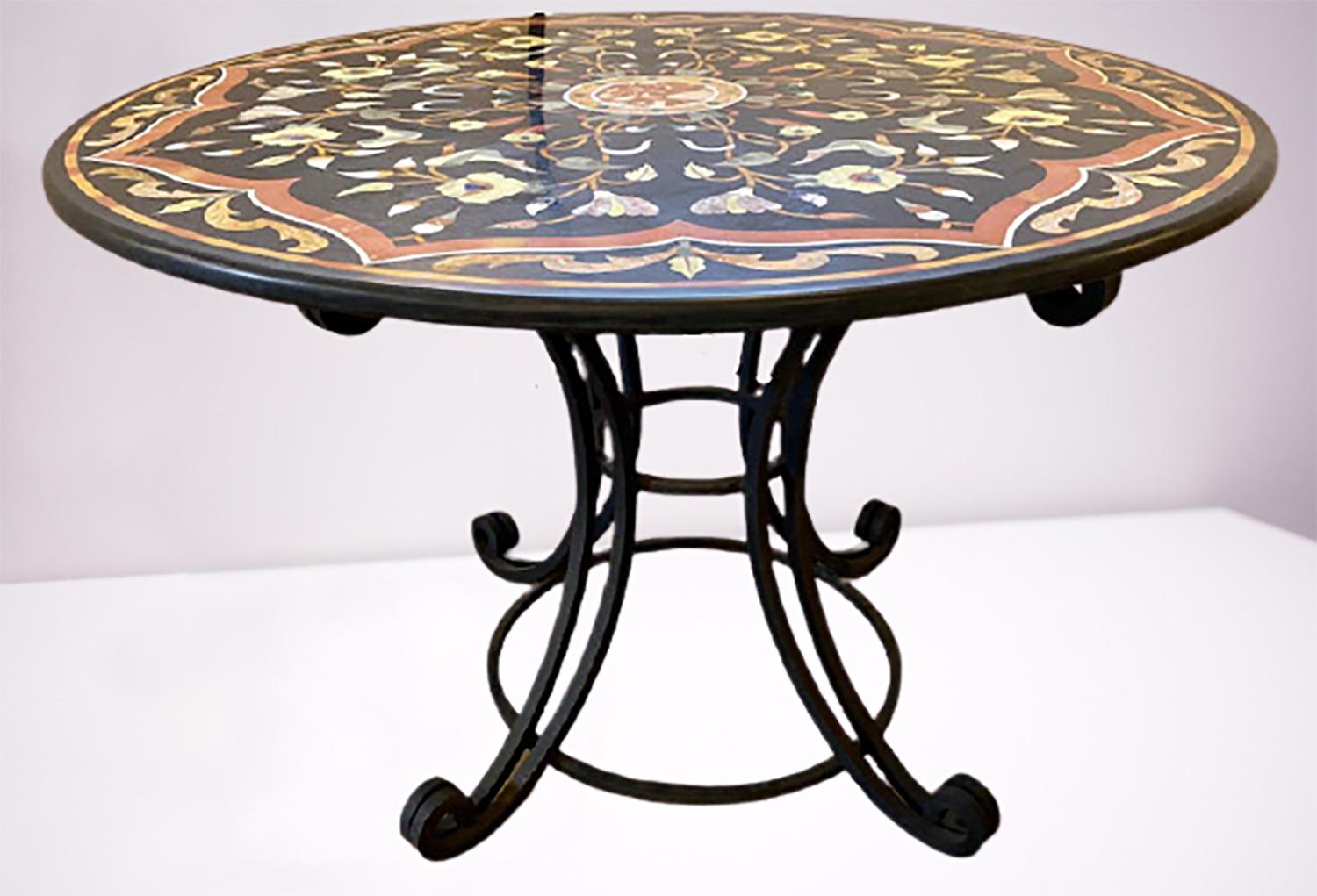 Pietra Dura stone inlaid round center dining table. Having a wrought iron table base this antique centre table is not a reproduction rather a good old one with hand details and a very solid and sturdy table base.
