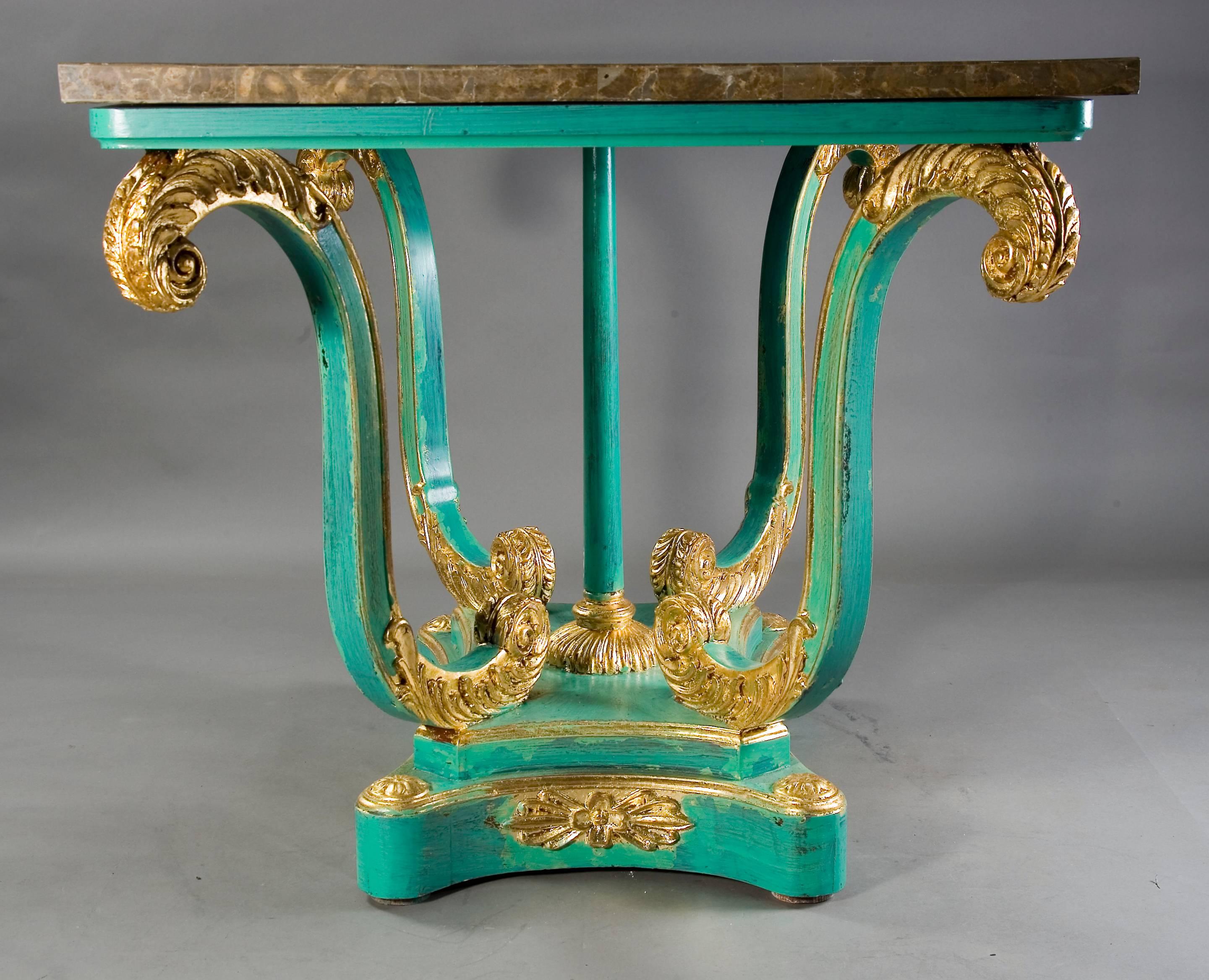 Solid beechwood, carved and turquoise colored and polished gold-plated. Square frame on S-shaped curved volutes. Centrally a column ending in a rosette-shaped base.
Four-sided base plate with classical decorations.

The unique Pietra, Dura tabletop.