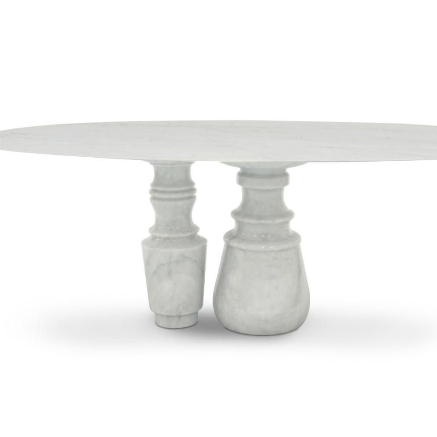 Playing with function and sculptural form, Pietra dining table shapes a timeless experience through its classical aura reminding the renaissance era and finest Estremoz white marble. Its oval top gently lies in three robust marble columns, each one