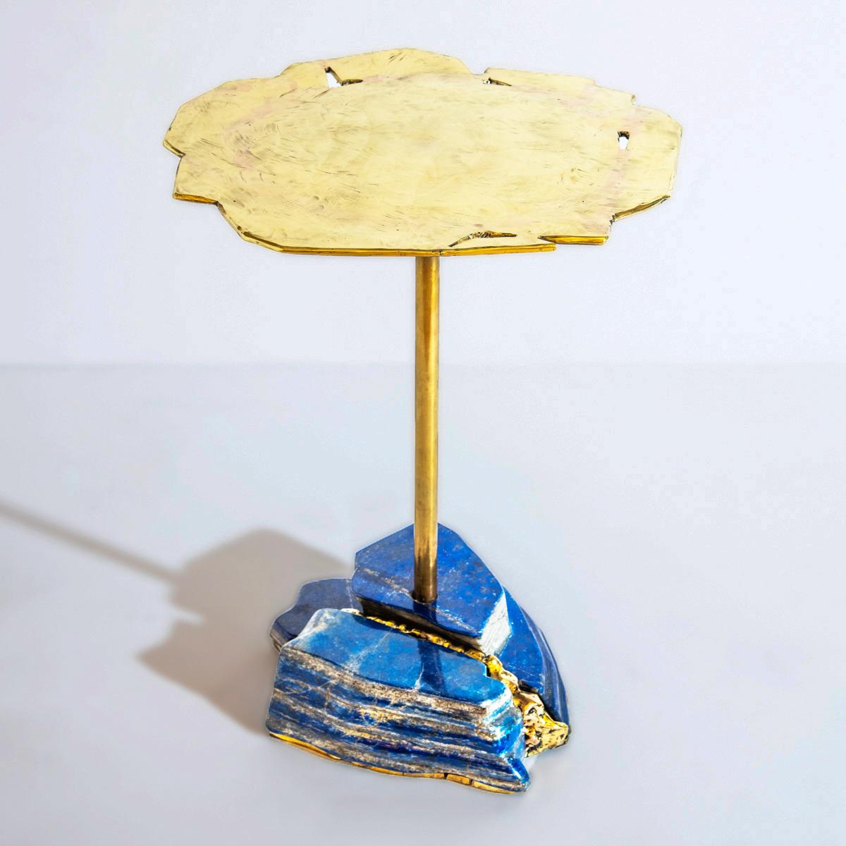 The Pietra side table is constructed on a lapis lazuli base created from several pieces of the precious stone and forged brass filling the gaps between them. The organic brass top is hand sculpted to create an undulating effect. Base composition and