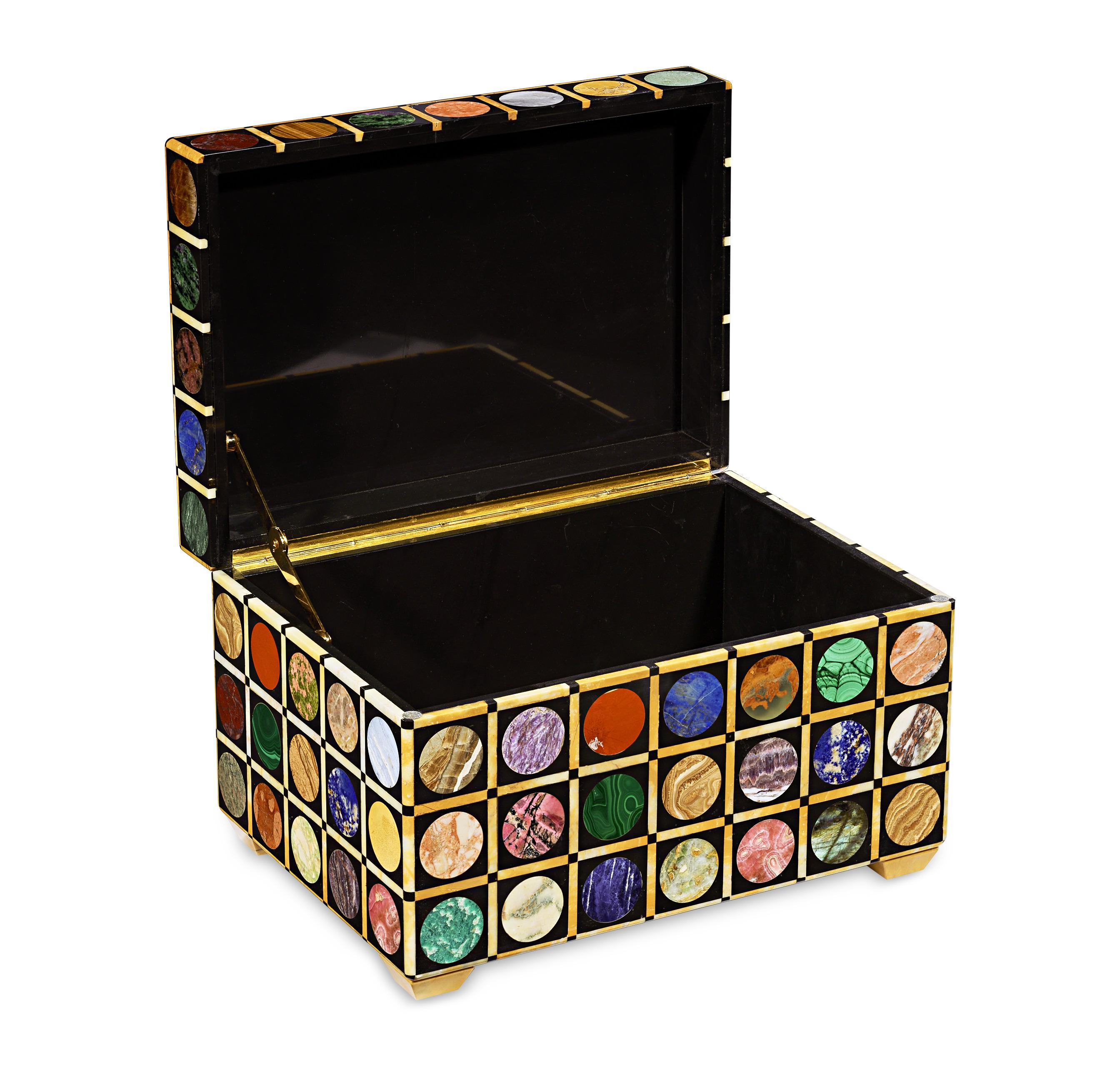 An exceptional relic of natural history, this casket bears 29 different types of rare marbles and hardstones from across the globe, inlaid into each panel in a neat, multi-colored grid pattern. The fascinating semi-precious stones hail from four