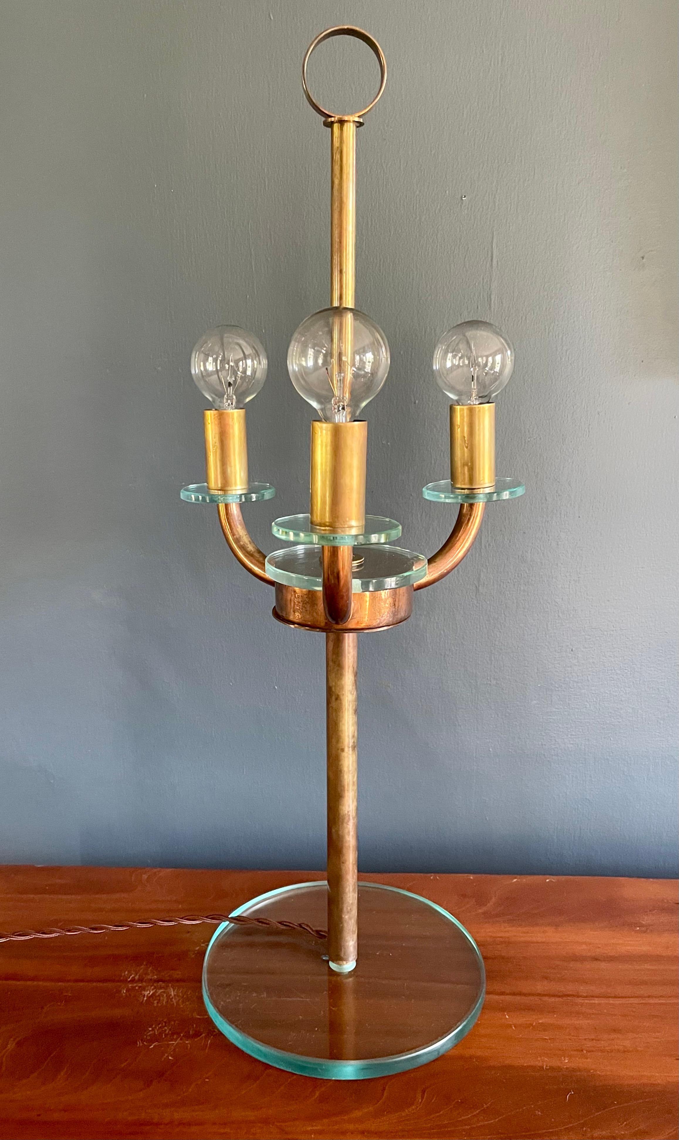 Pietro Chiesa copper and glass table lamp. Three arm vintage copper tubing and fontana art glass style table lamp with brass ring handle and glass base. Newly electrified with switch on silk twist cord. Italy, 1940's

Dimensions: 23