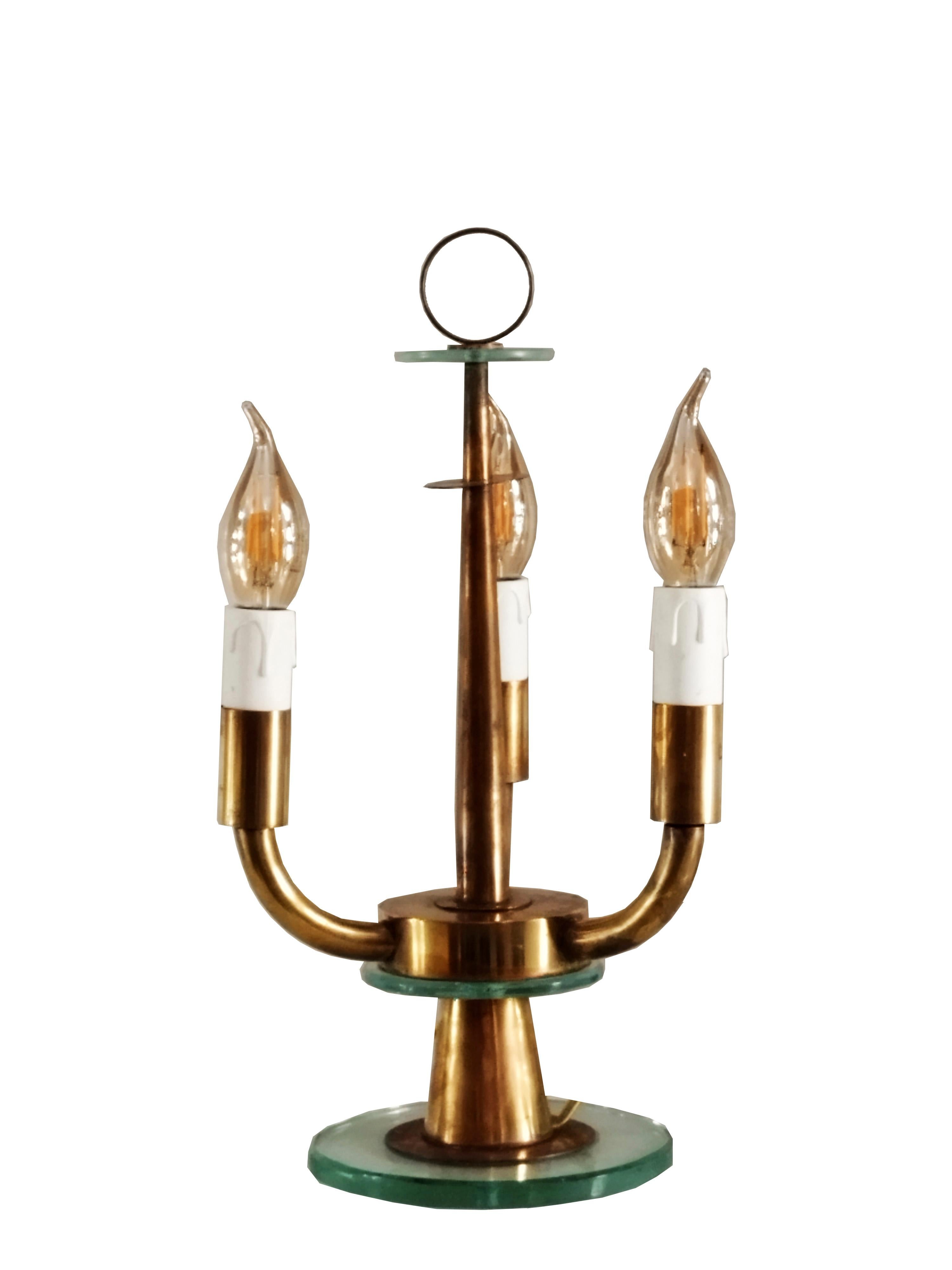 Table lamp from the late 1940s by designer Pietro Chiesa, artistic director of Fontana Arte until 1948. In the table lamp, the particular wear of the brass and grinding of the glass, with its Nile green hue, make the lamp fascinating and elegant. In