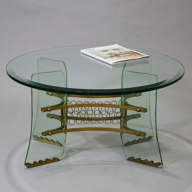 Pietro Chiesa for Fontana Arte Glass and Brass Table made in Italy around 1950
A rare crystal occasional table featuring four very thick shaped crystal legs with small brass feet, a center brass mounting system with swirling decorative brass accents