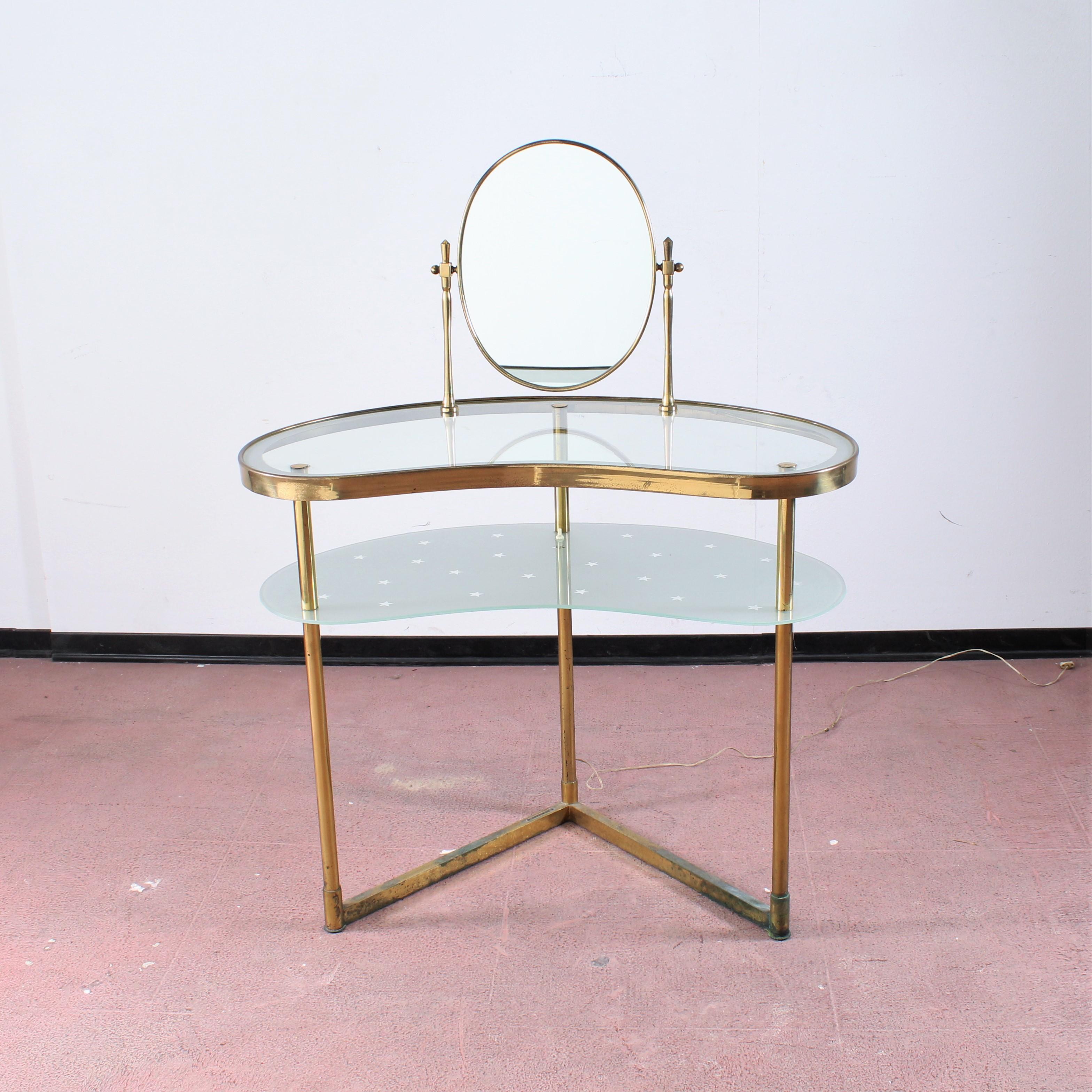 Wonderful brass and glass vanity with tilting mirror. The lighting enhances the starry motif.
Attributed to Luigi Brusotti, 1940s, Italy
Wear consistent with age and use.