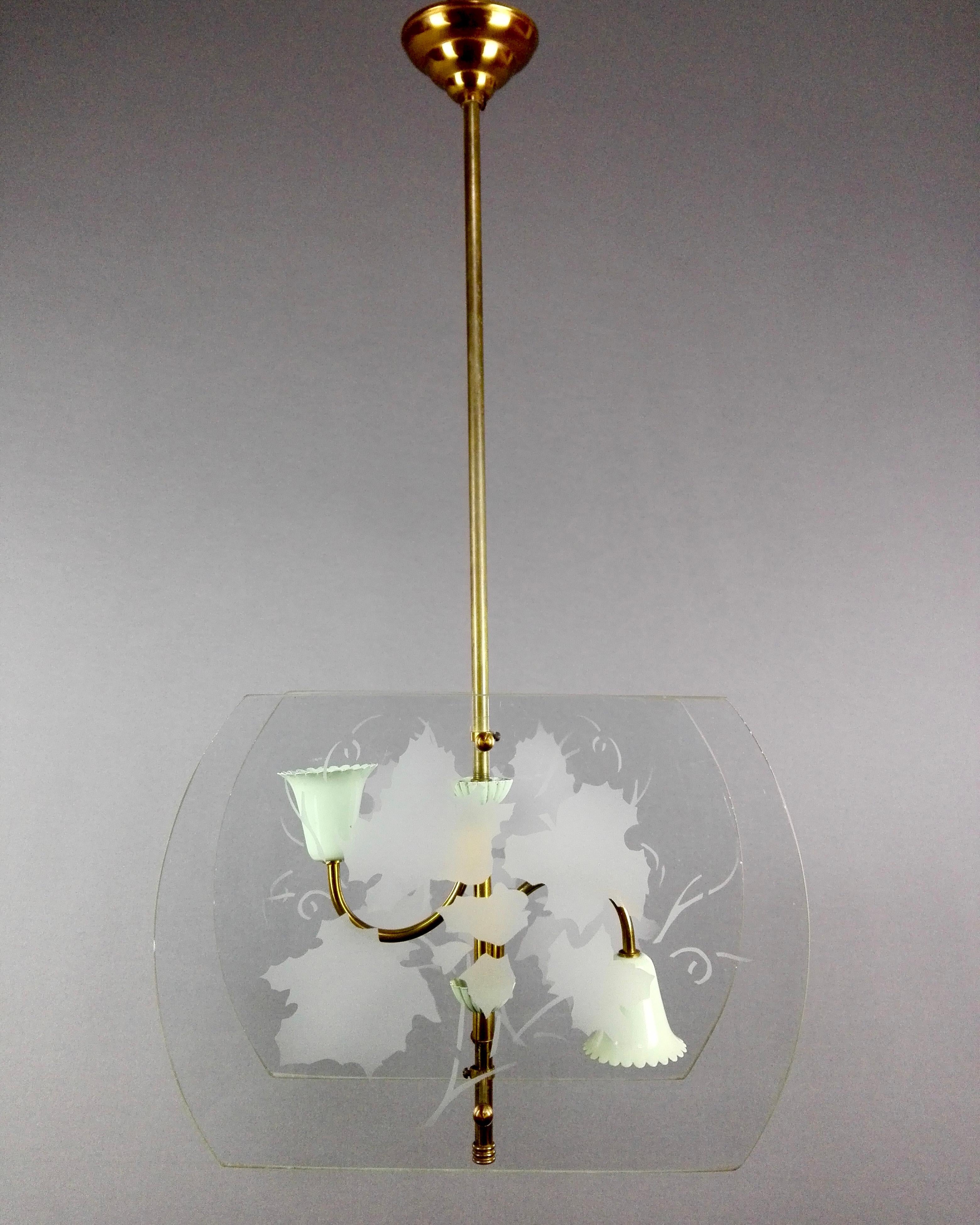 A stylish 1940s Italian two-light lantern in the style of Pietro Chiesa with two glass panels decorated with vine leaves, brass frame and pale-green lacquered aluminum lamp holders cover cups. 
Total height with stem: 99 cm/ 39 in 
Each glass