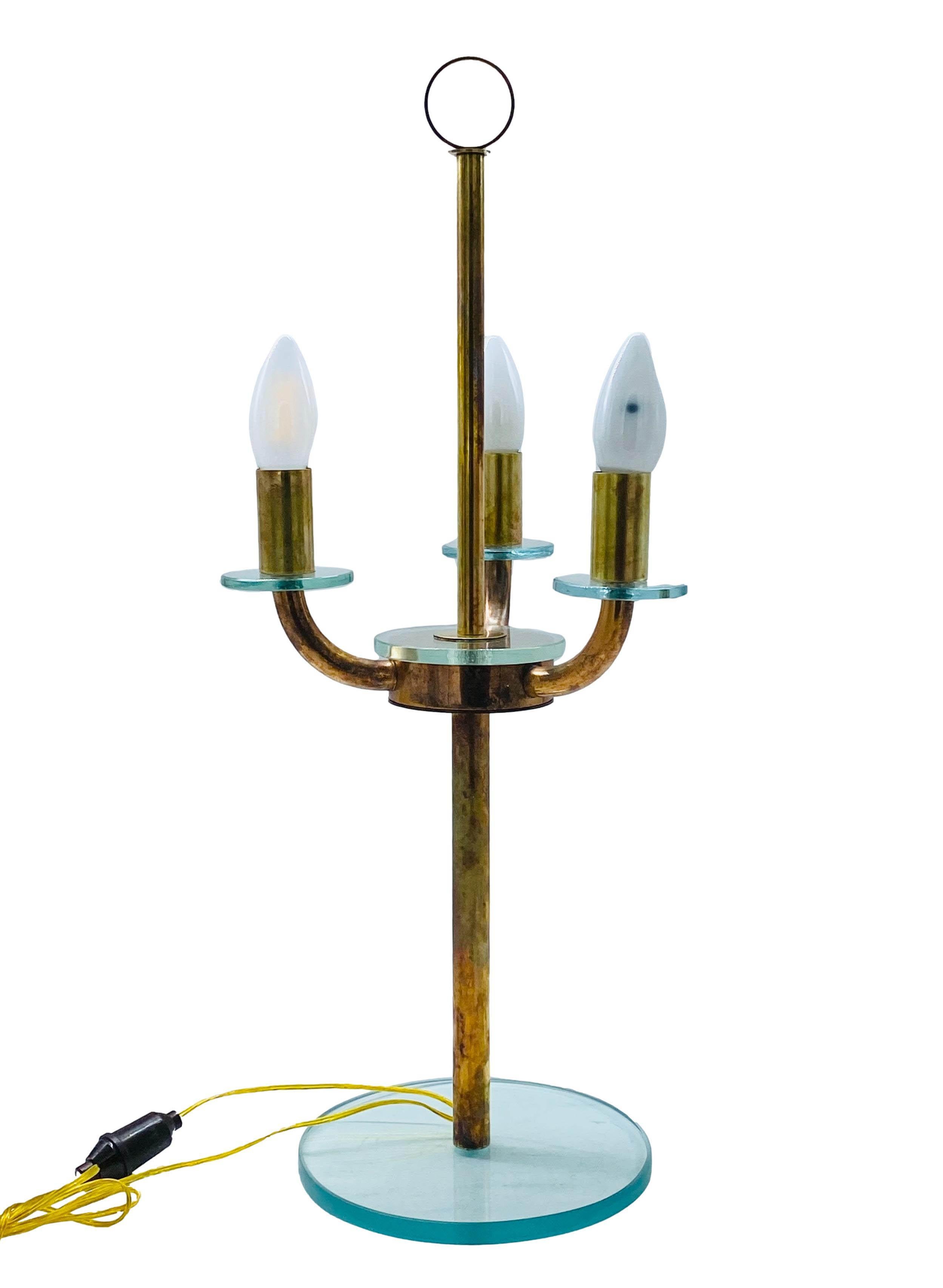 Table lamp from the late 1930s designed in the style of Ticino designer Pietro Chiesa, artistic director of Fontana Arte until 1948. The particular wear of the brass and grinding of the glass, with its Nile green hue, make the lamp fascinating and